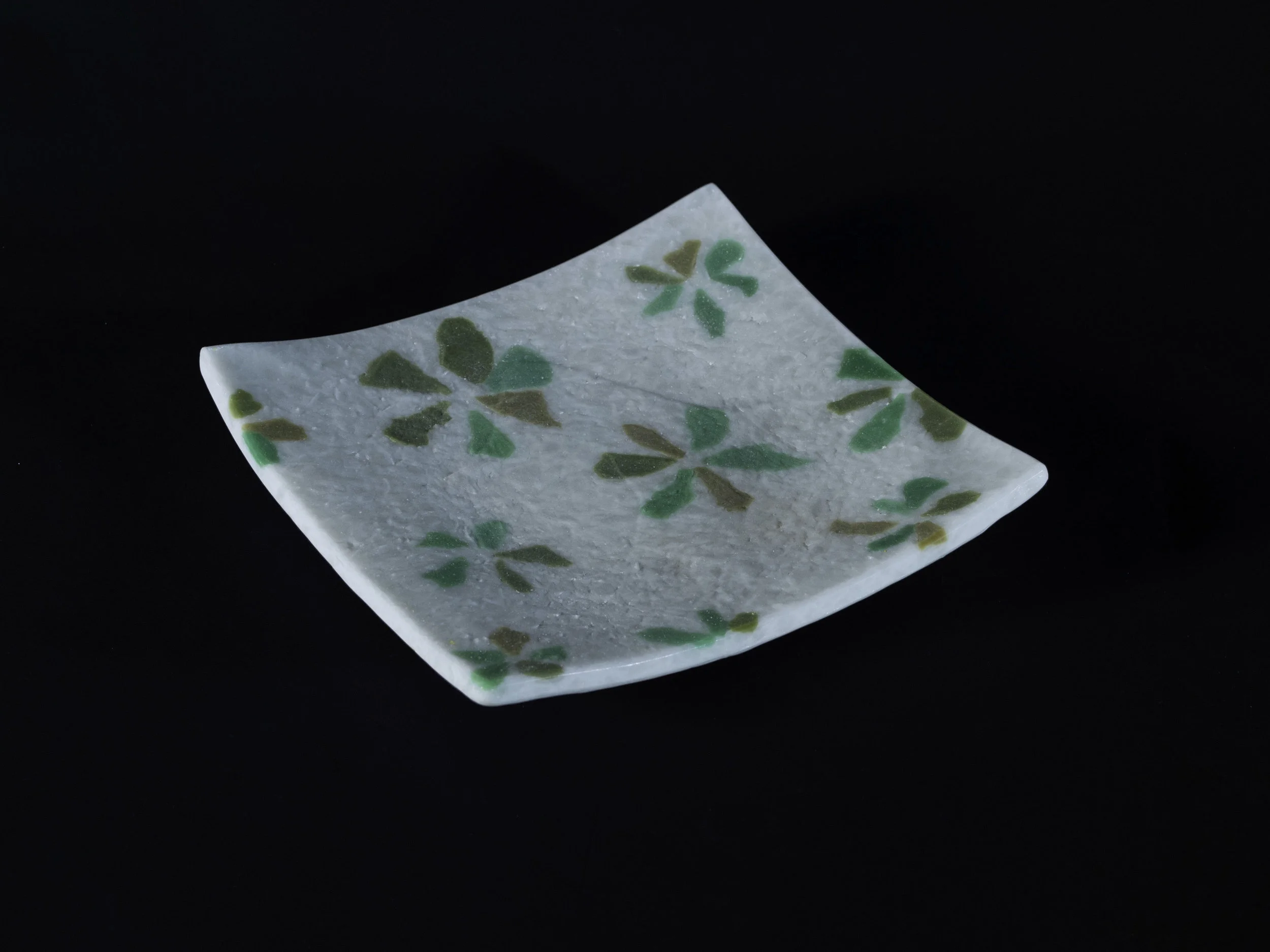 Fused and slumped, white with green flower pattern