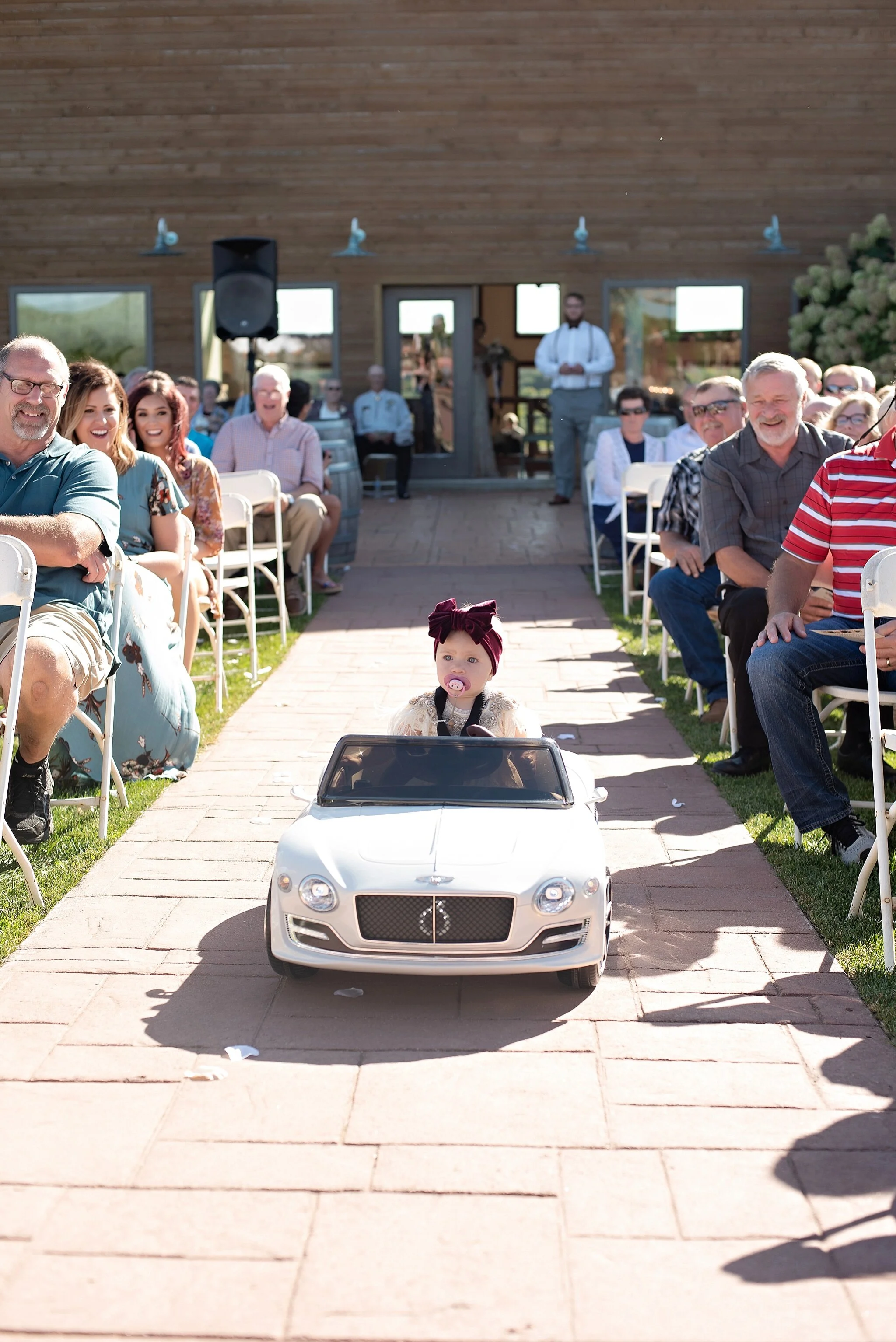 daughter of the couple rides a bentley up the aisle