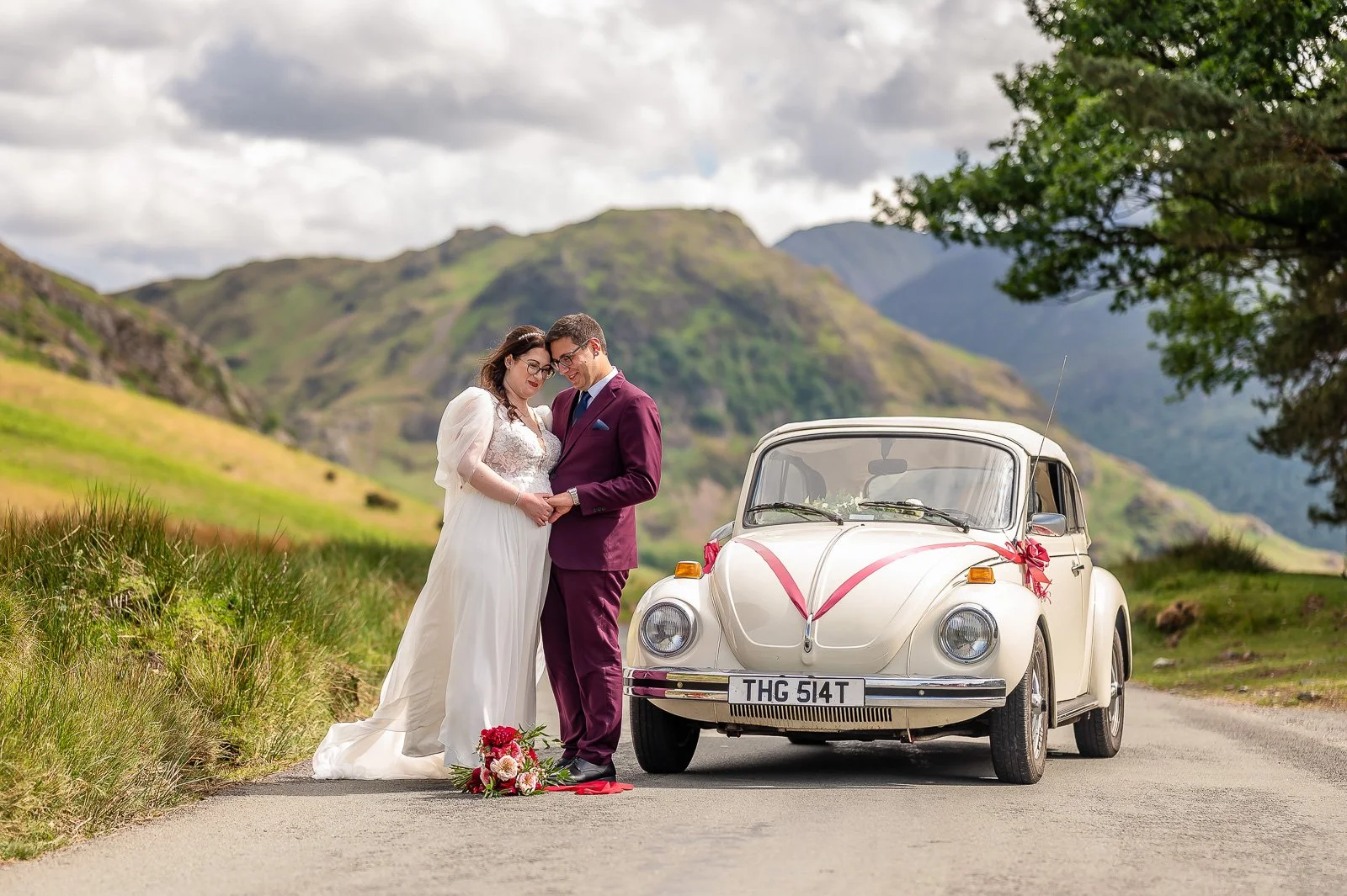 Bride and Groom in the Lake District with their Wedding Car, a VW Beetle