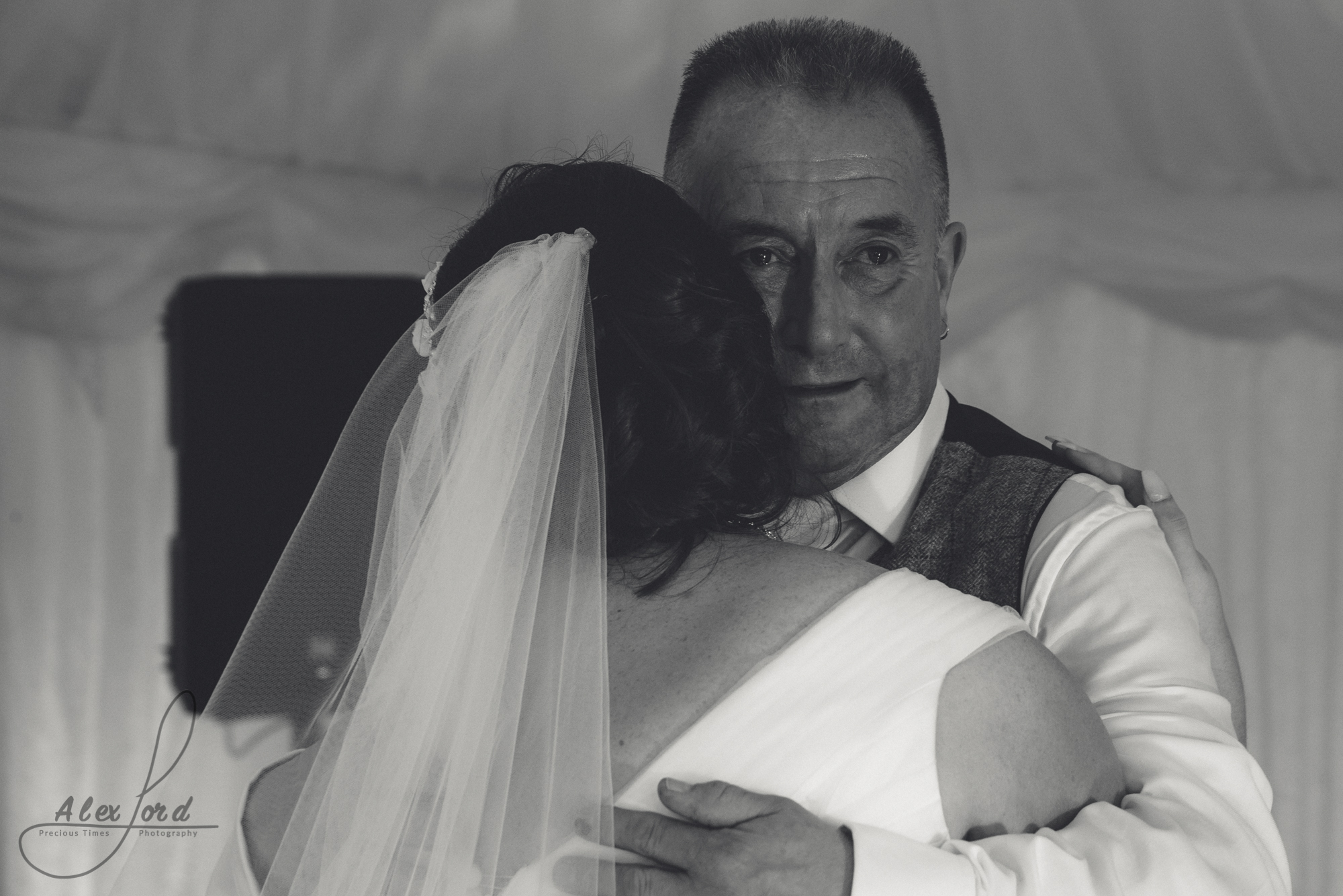 The bride shares a dance with her emotional dad.