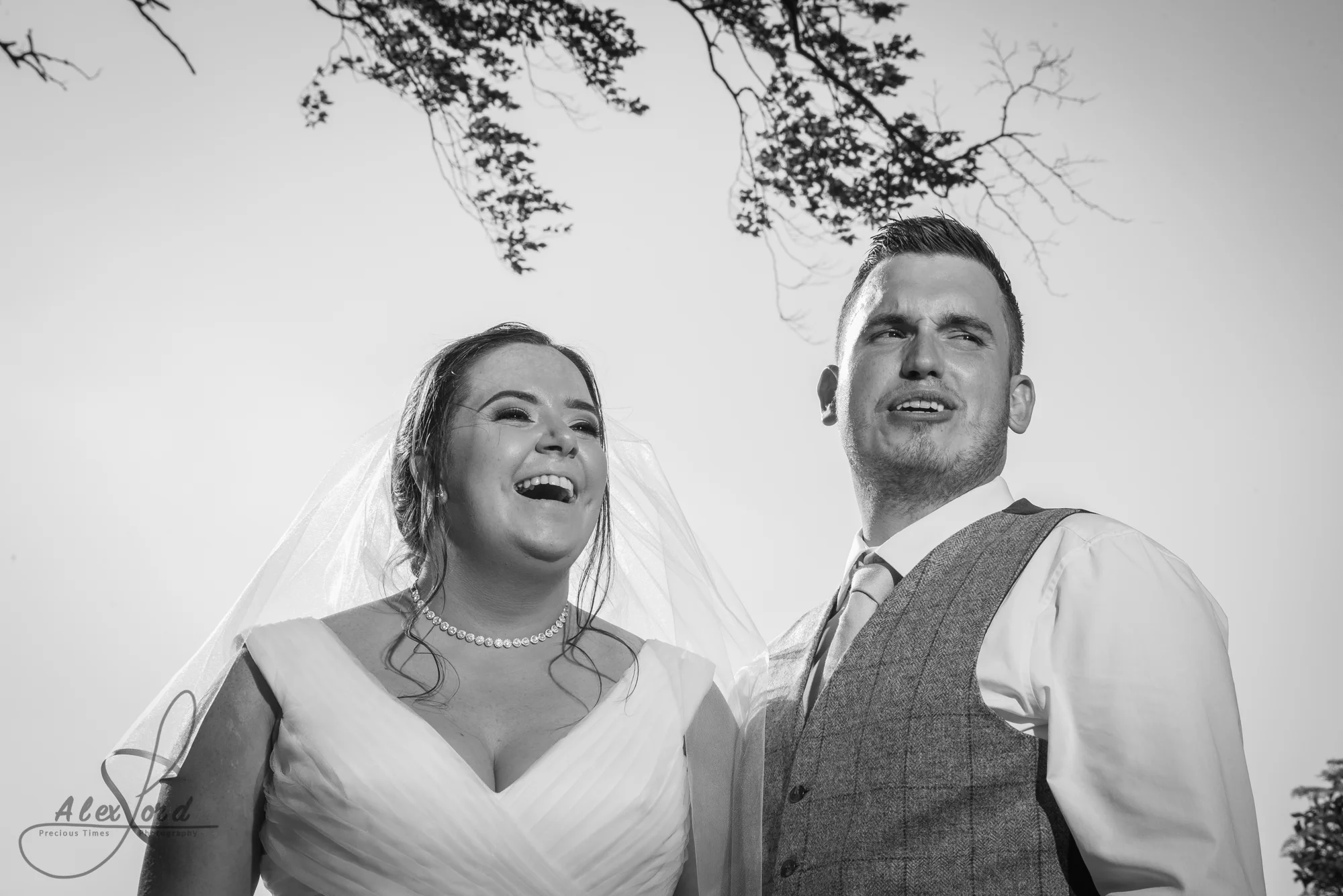 The bride laughs out loud during their wedding photo shoot