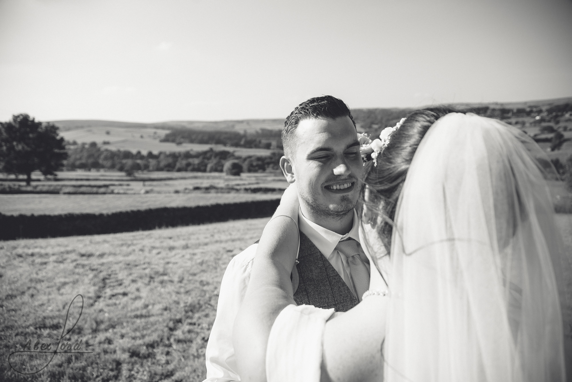 Black and white image of the groom looking into the brides eyes