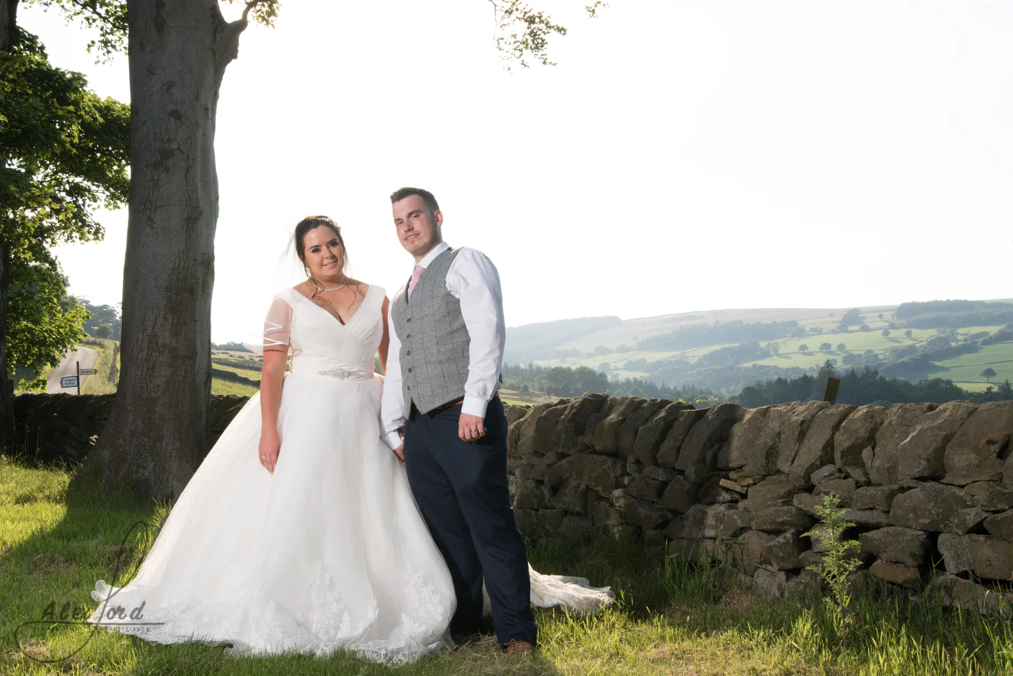 Bride and groom with sunlight streaming onto their faces