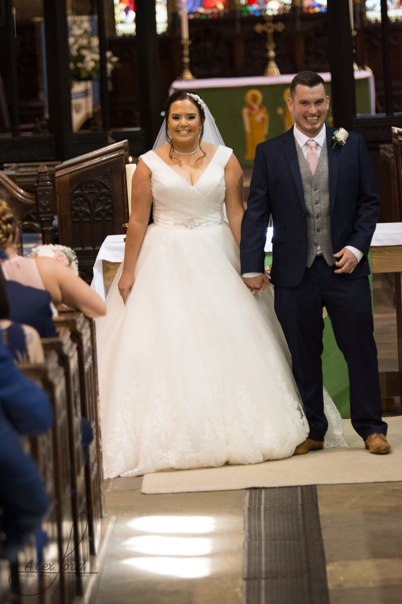 The bride and groom look towards their wedding guests after they have just got married