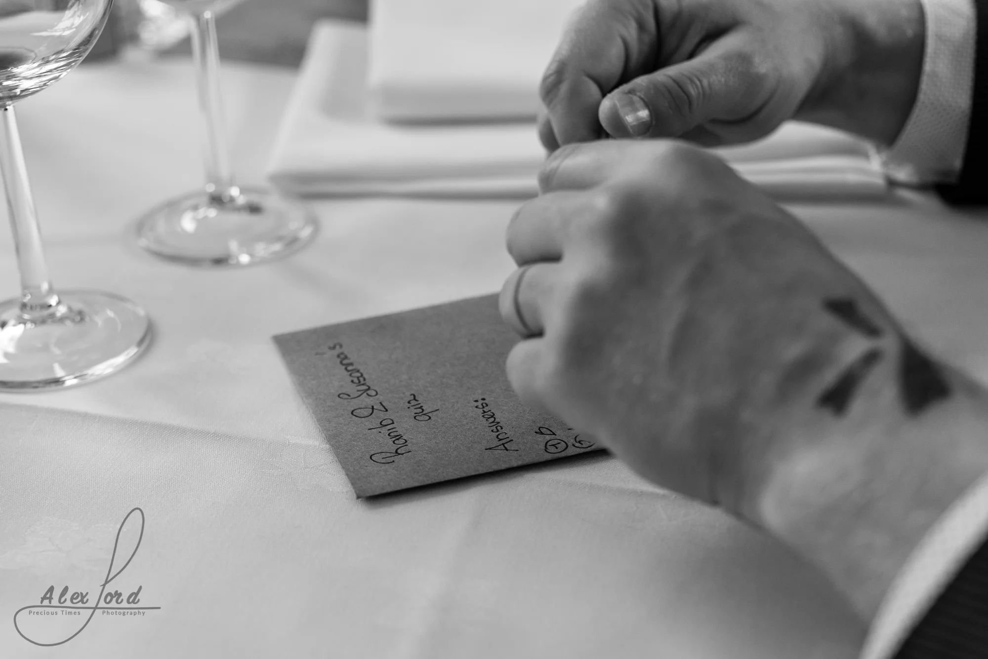 Close up image of a wedding guests hands during the start of the speeches