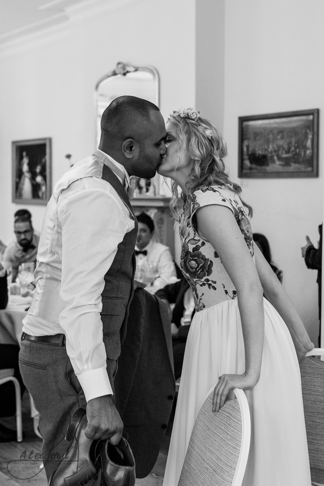 Bride and groom share a kiss at the end of the mr and mrs game they play in front of their wedding guests