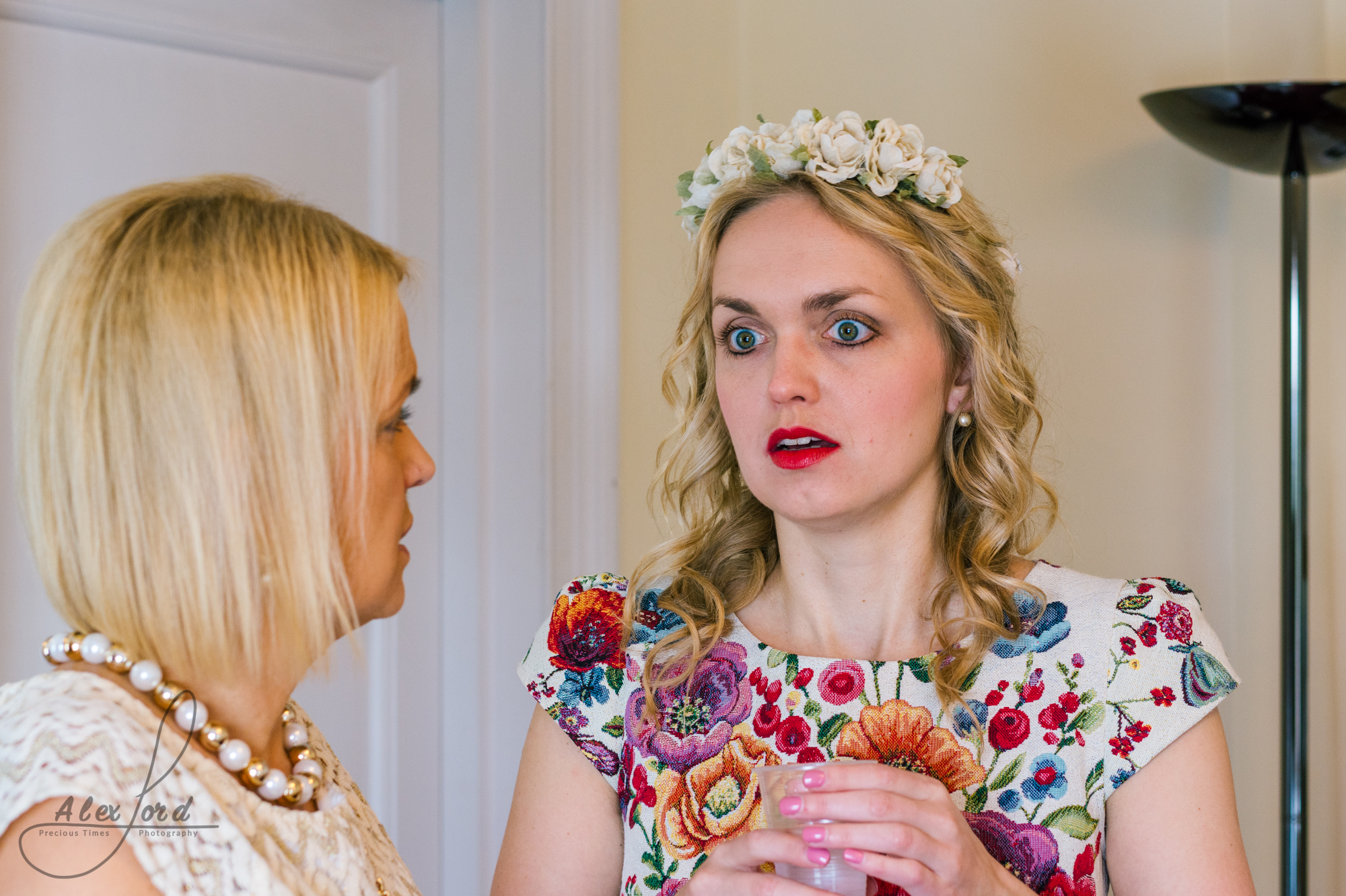 Bride chats to her friend before she gets ready to enter the wedding ceremony room