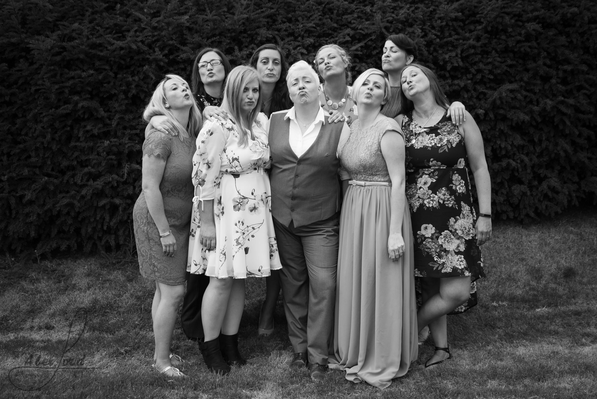 some of the brides family gather outside for a late night family group photograph