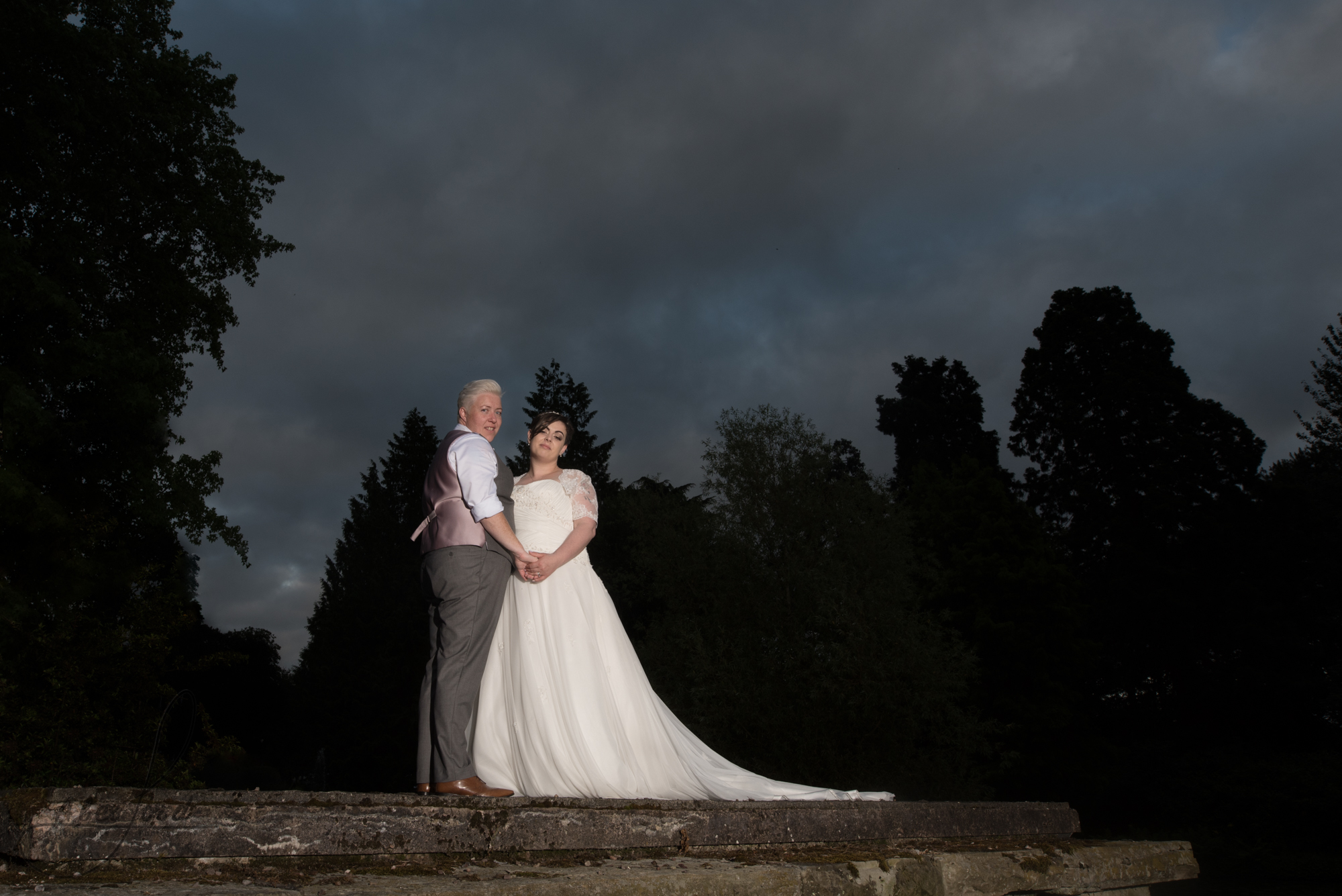 the bride and bride go outside for their wedding photography in the dark