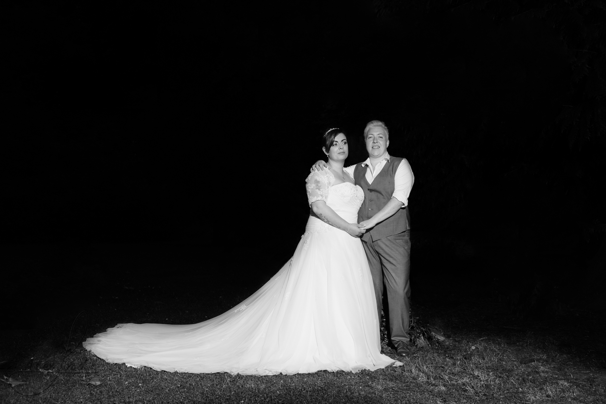 the bride and bride go outside for their wedding photography in the dark