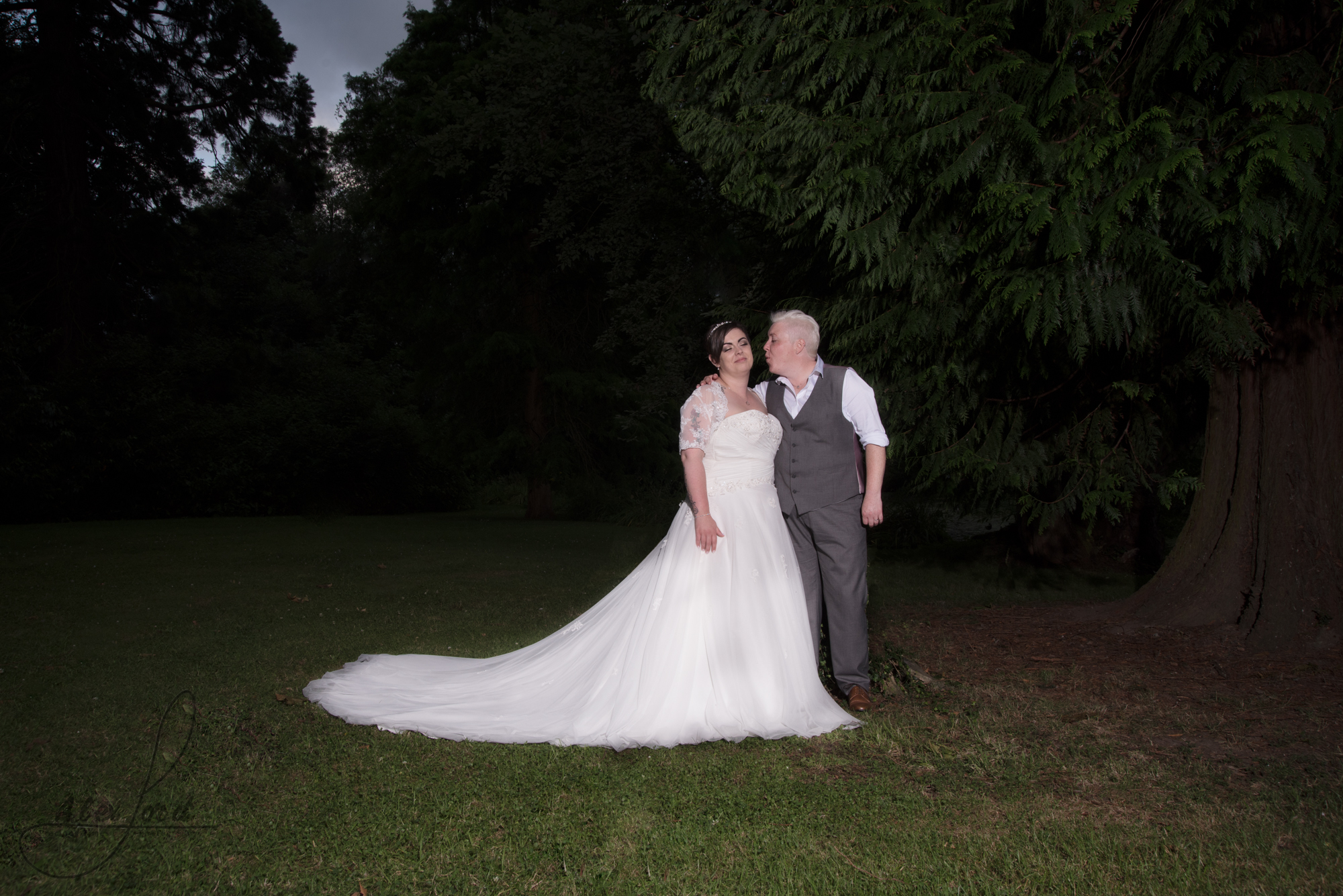 the bride and bride go outside for their wedding photography in the dark