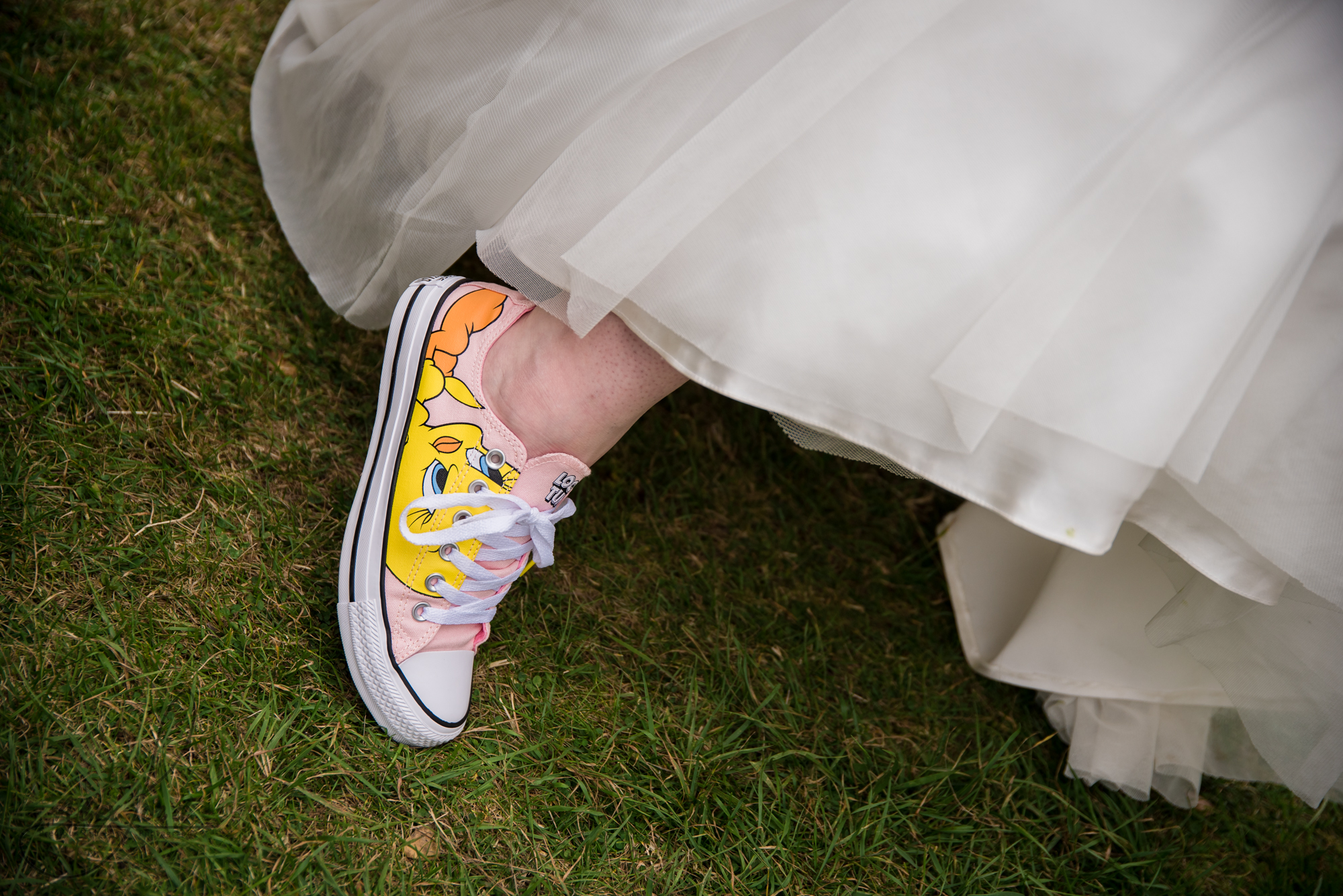 the bride shows her converse shoes to the camera