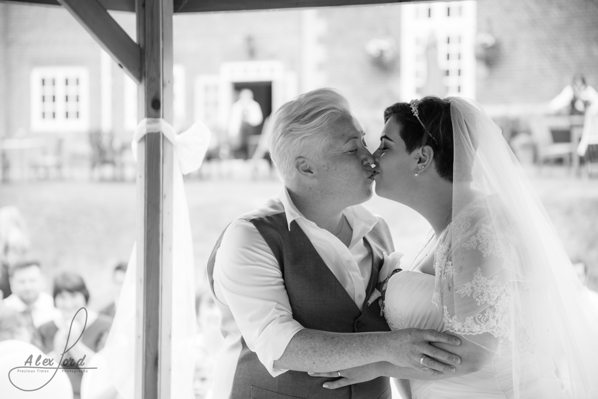 the bride and bride share their first kiss as a married couple