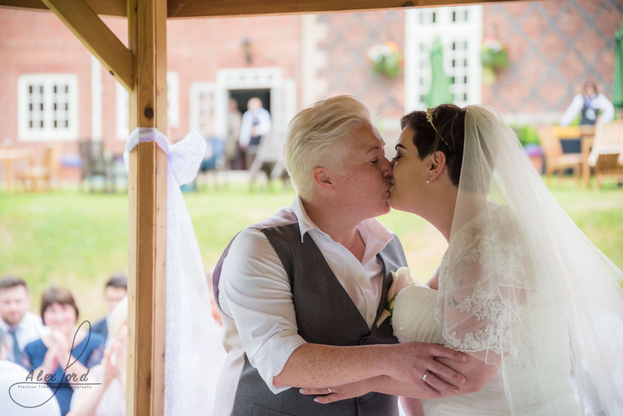 the bride and bride share their first kiss as a married couple