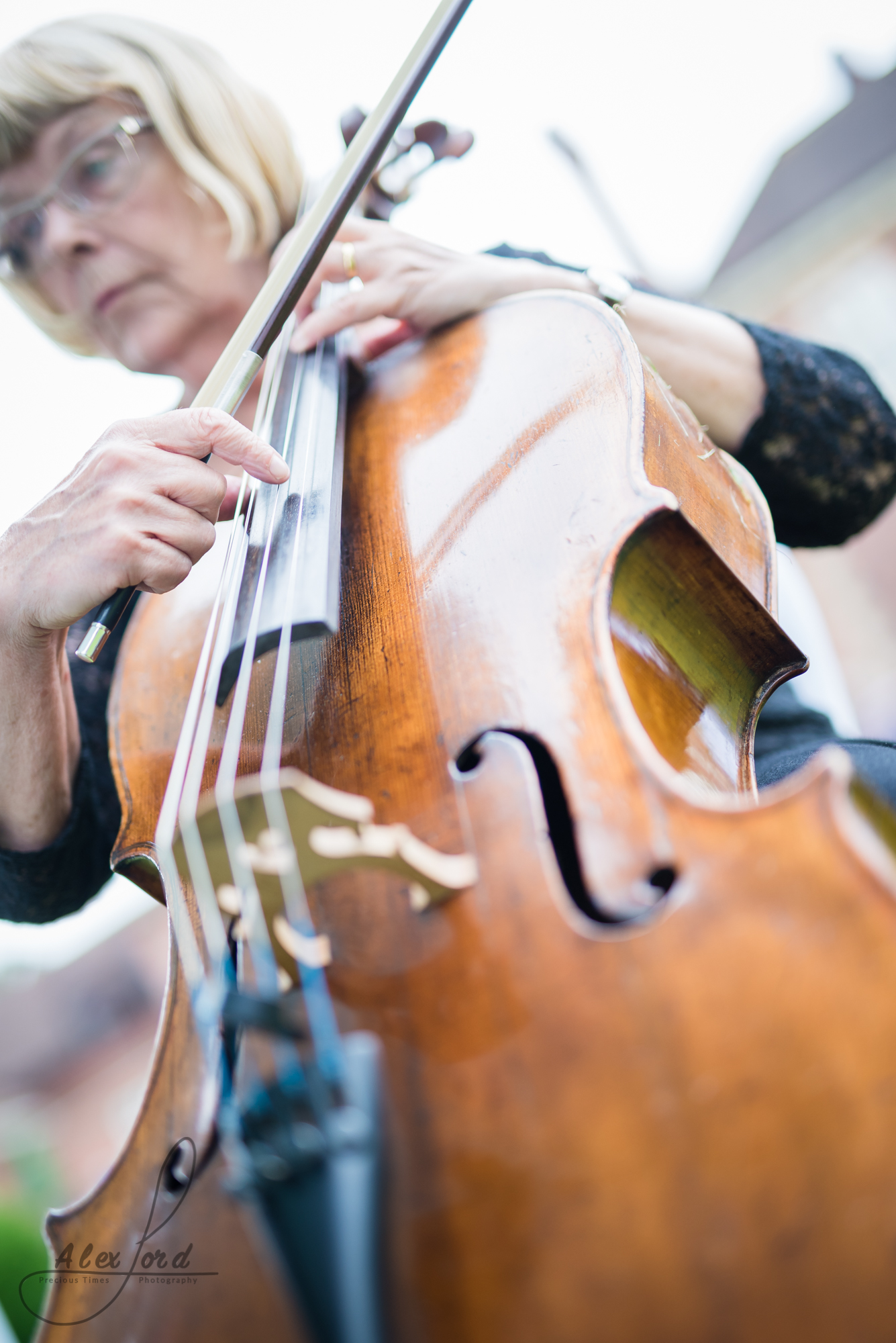 cellist plays during the wedding reception welcome drinks outside the venue