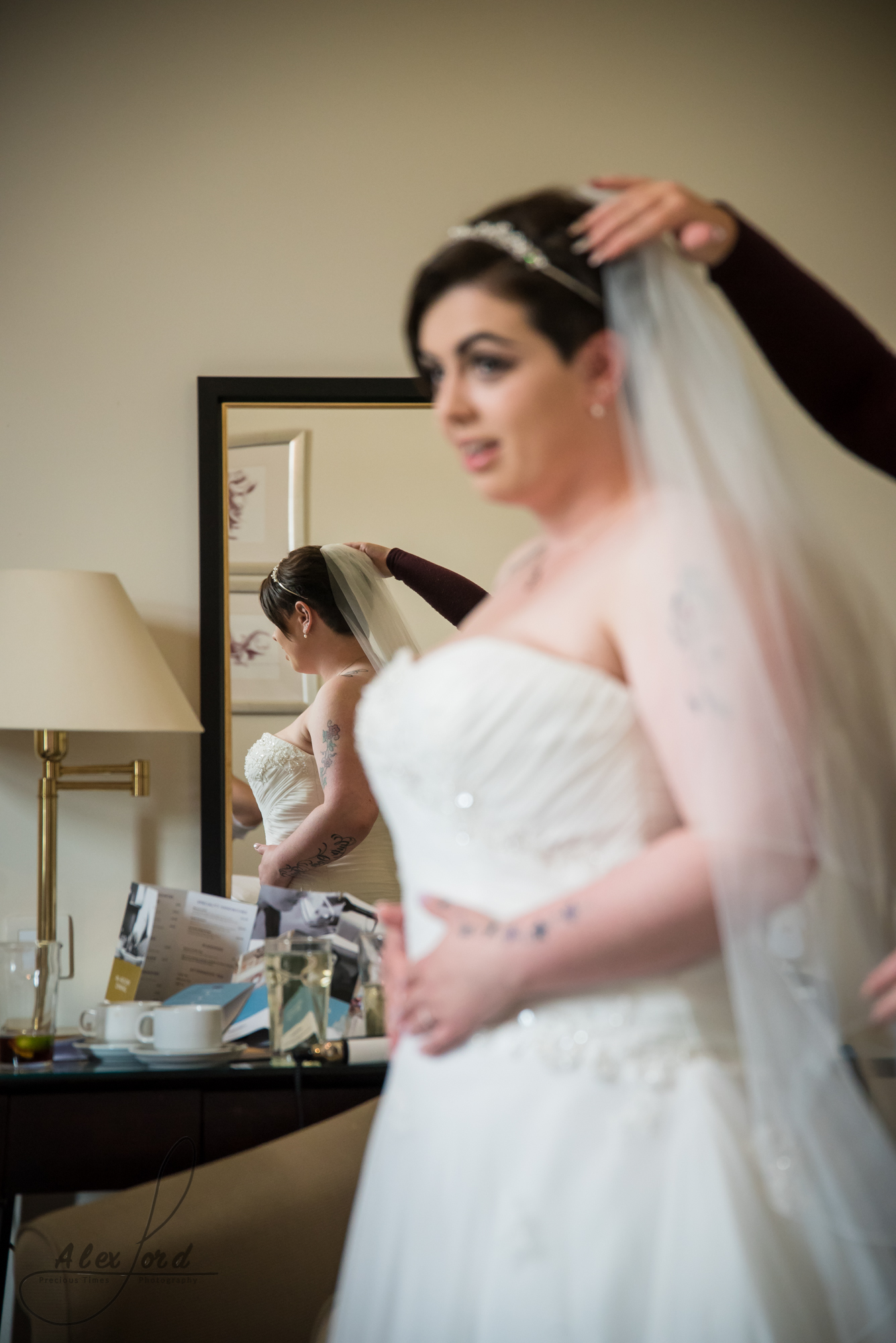 the bride has her veil fitted just before heading down for the wedding ceremony