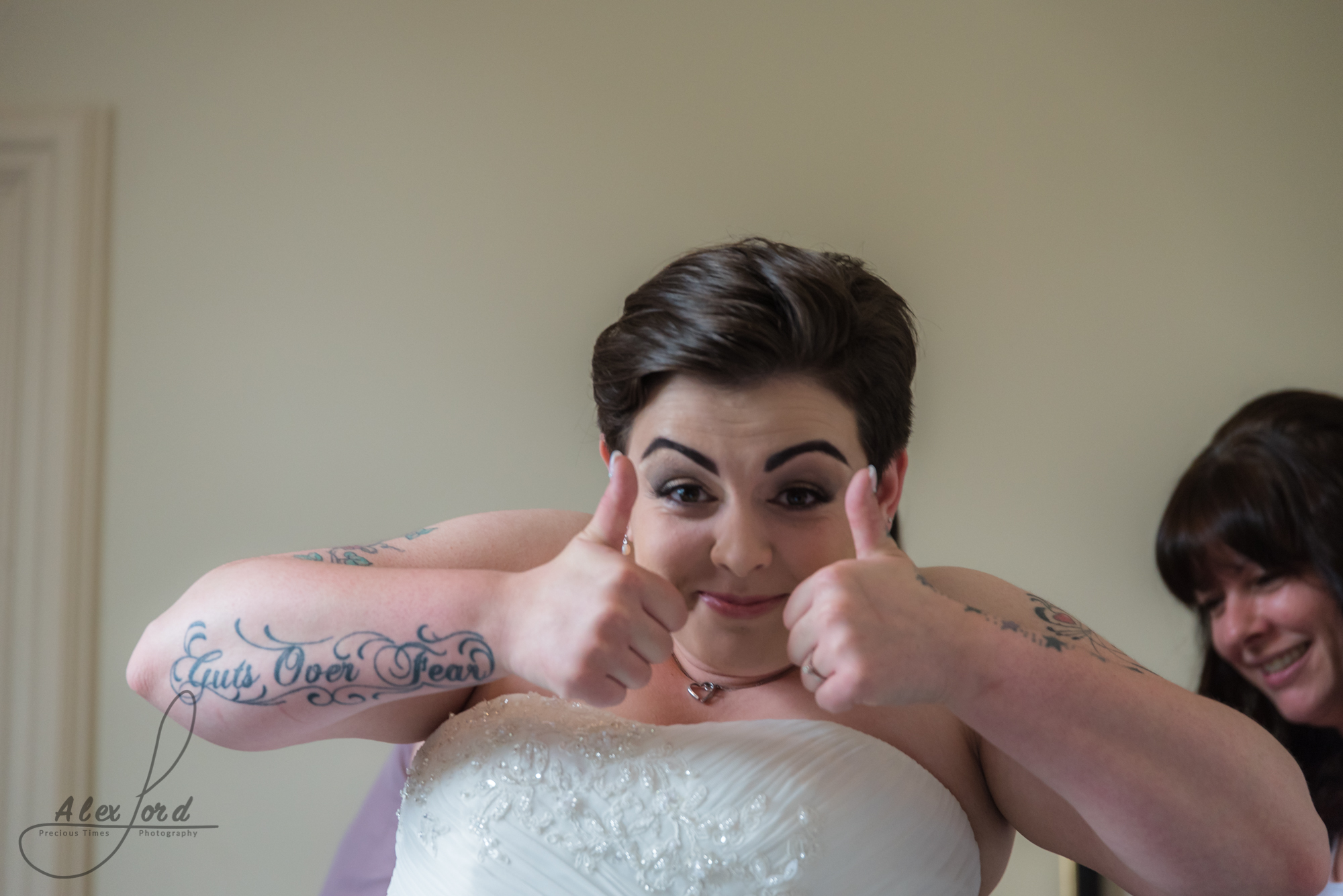 the bride does a thumbs up to the camera