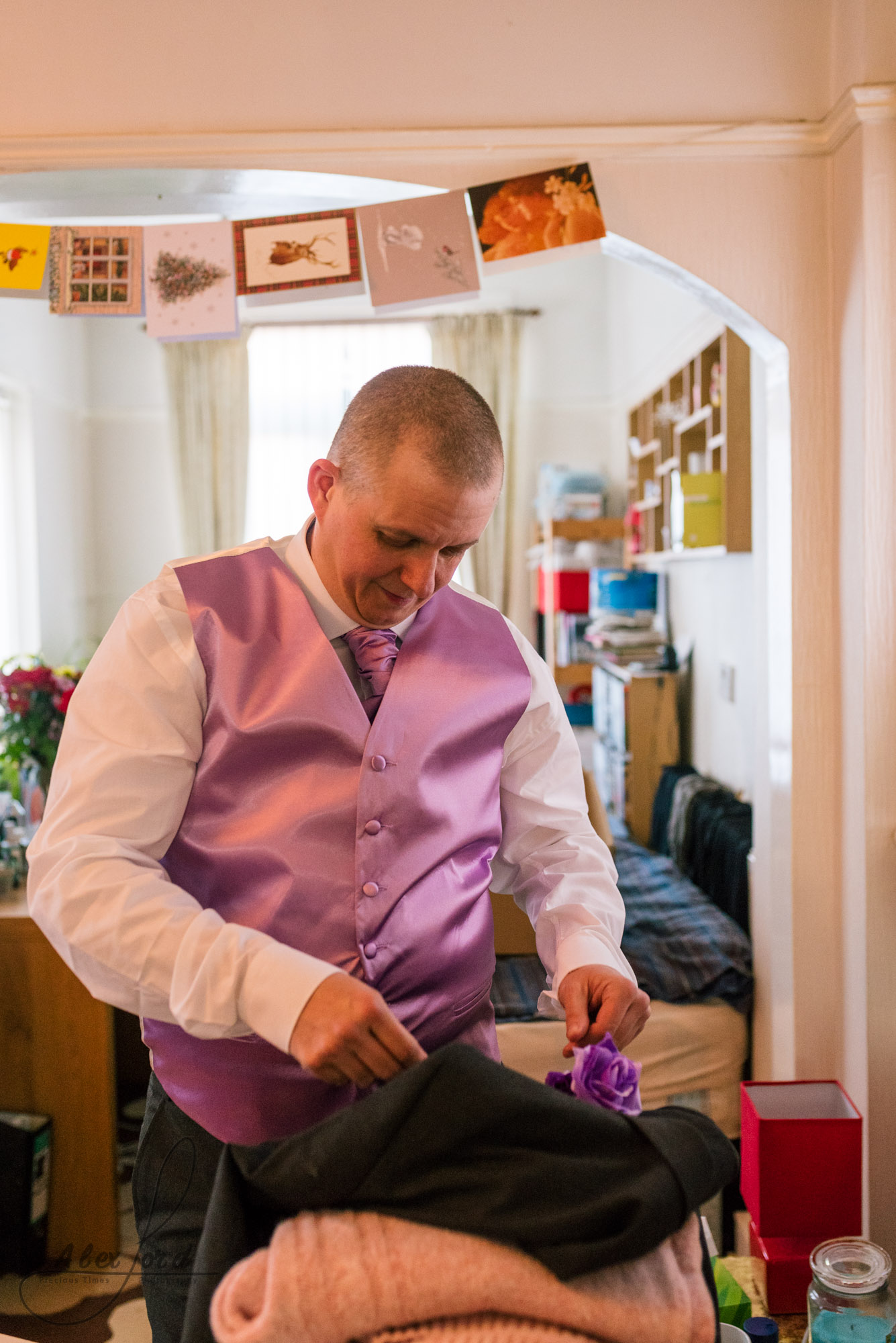 the best man make some finishing touches to his suit before him and the groom leave for the wedding ceremony in liverpool