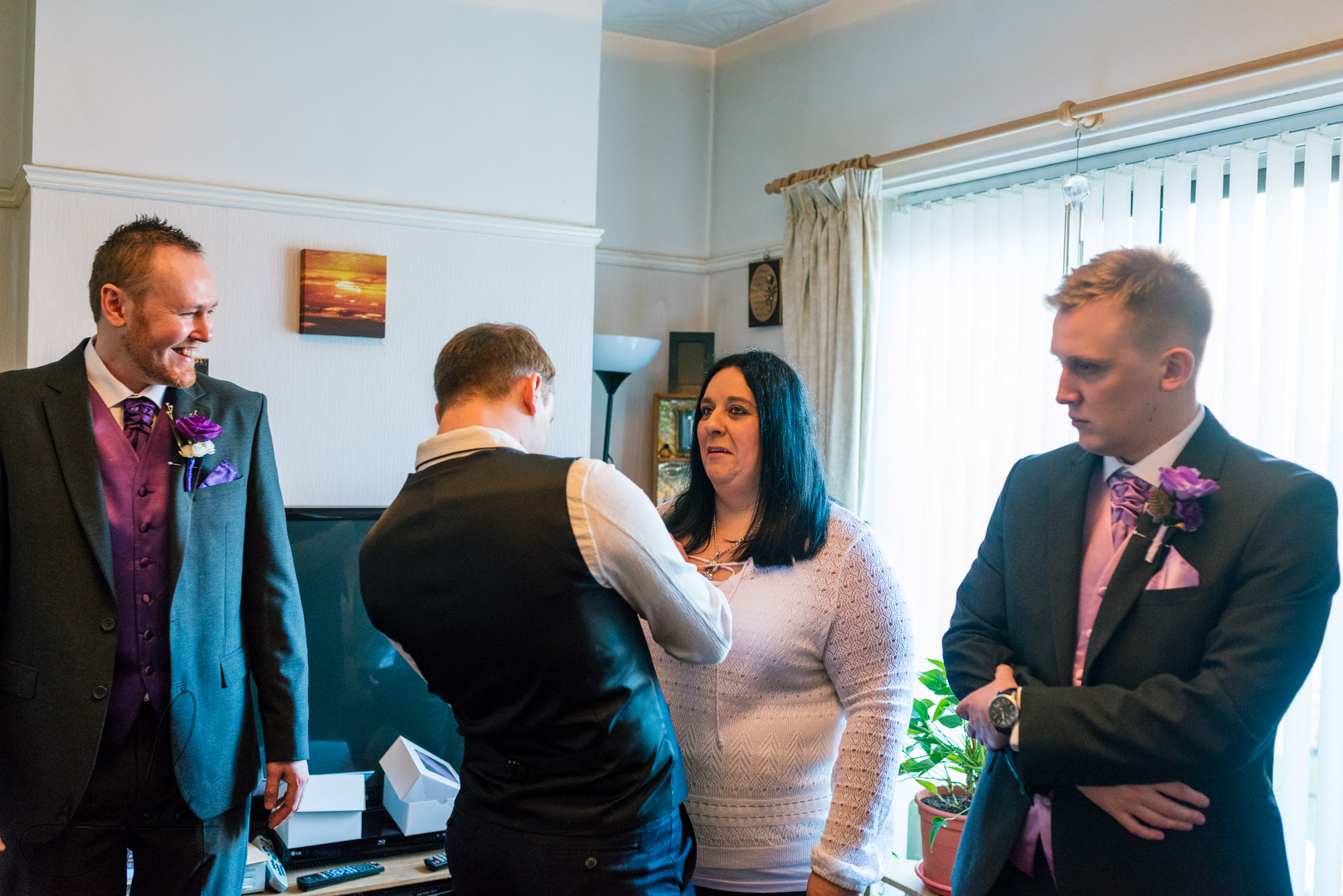 the groom spends some time with a few members of his family in his house, before leaving for his wedding ceremony in liverpool