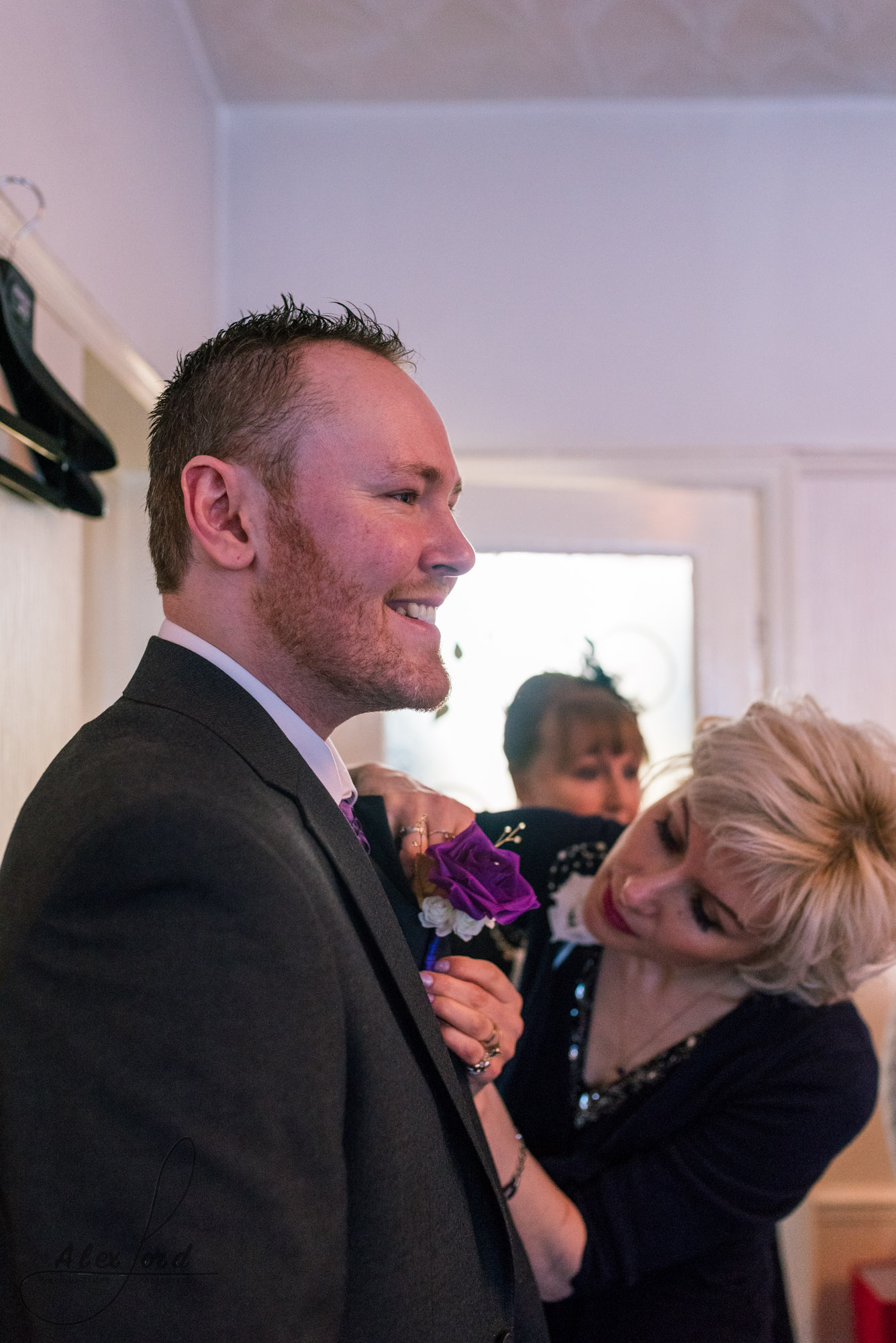 the groom has a really big smile, all ready to set off for his wedding ceremony