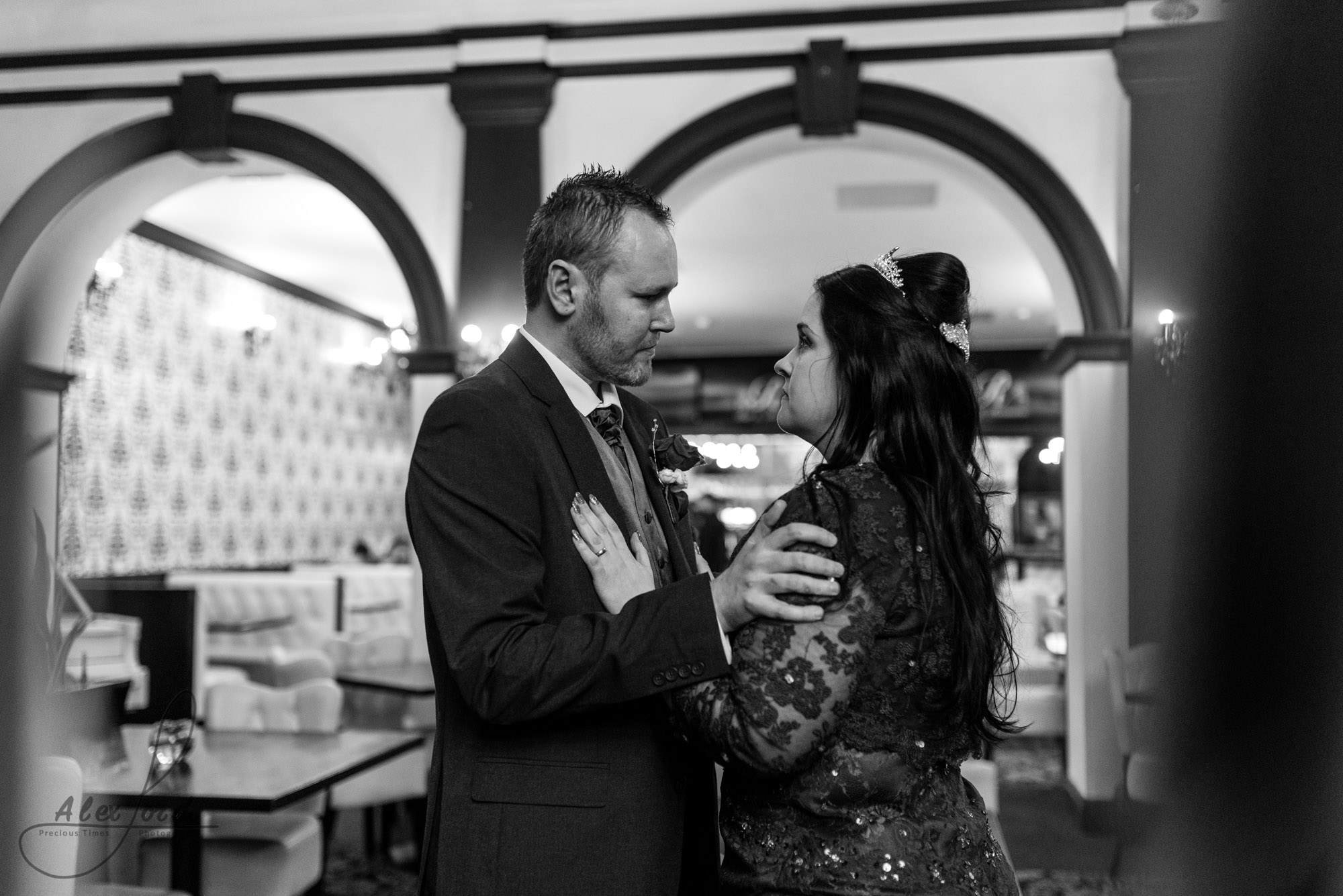 the bride and groom stand inside the venue for some wedding photography