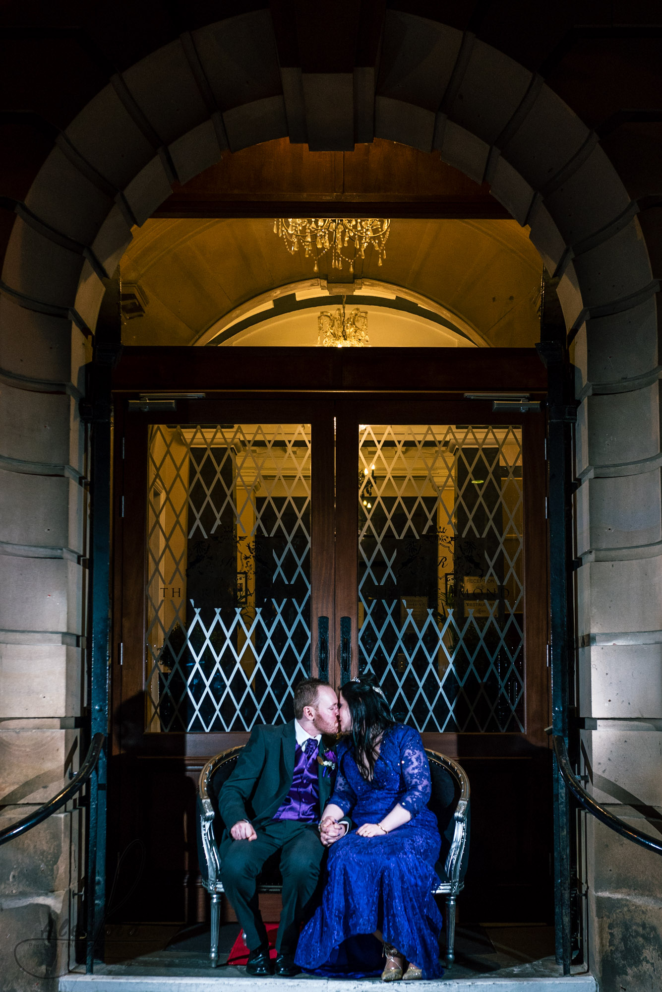 the bride and groom sit outside the richmond hotel for their evening photoshoot