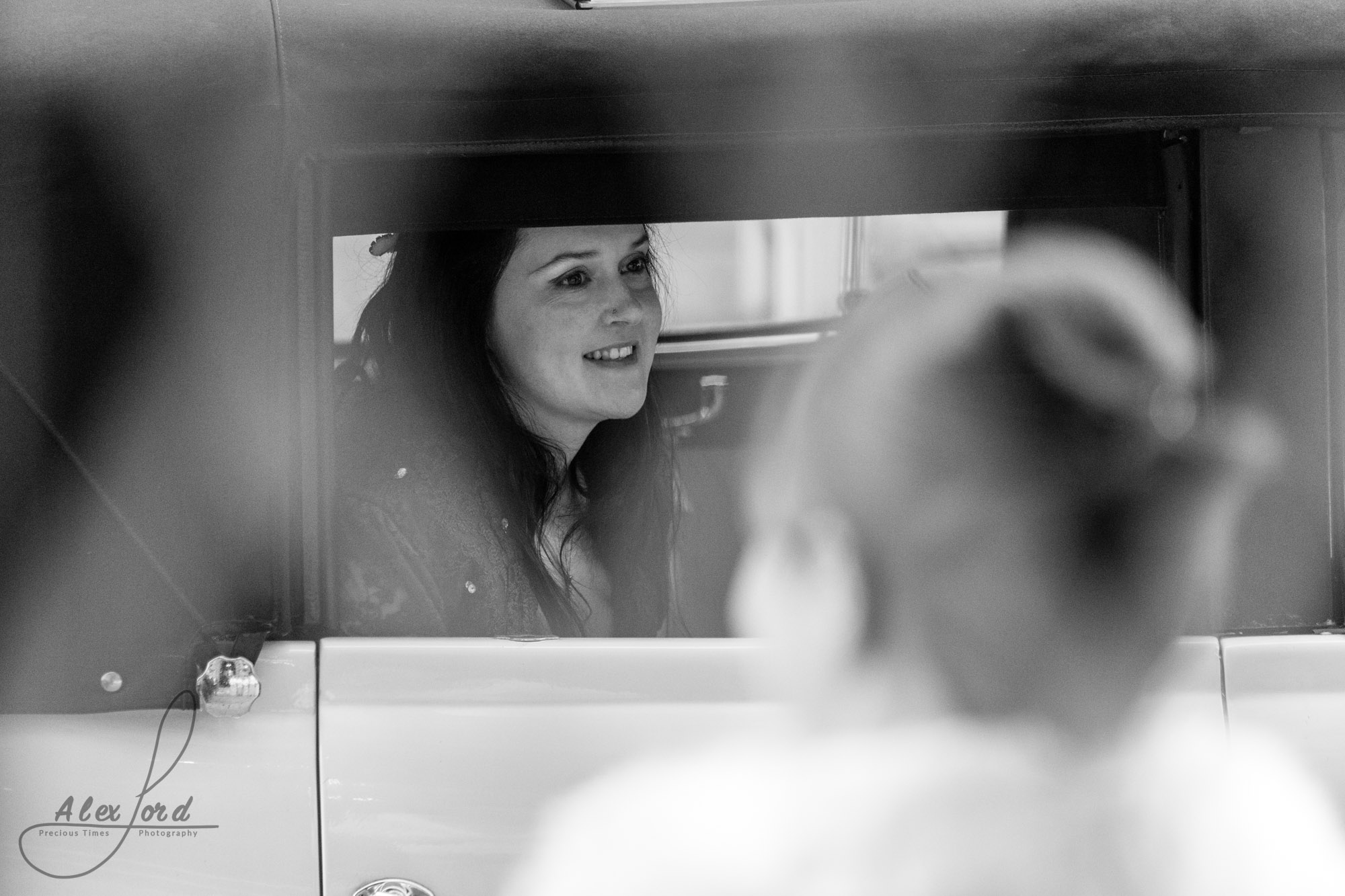 the smiling bride arrives at the richmond hotel liverpool where her bridesmaids are waiting for her