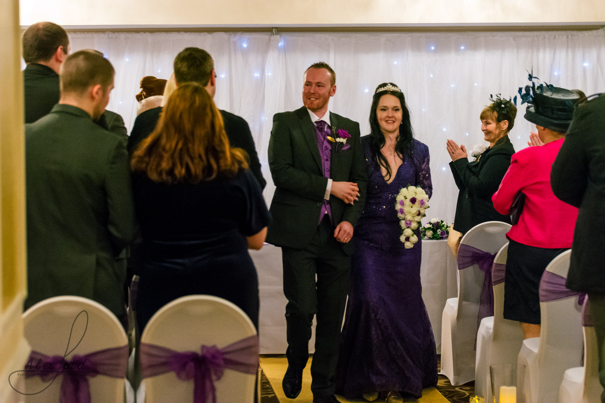 the bride and groom walk back down the aisle together after their wedding ceremony