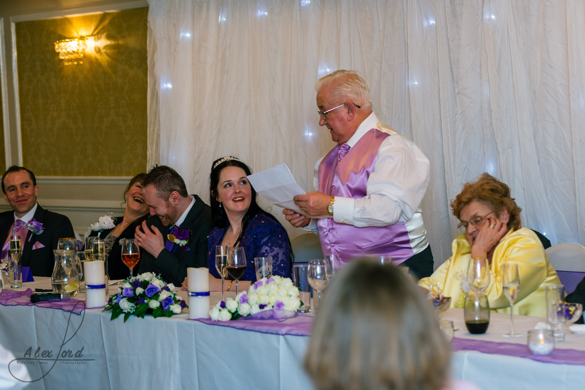 the brides father addresses wedding guests during his speech