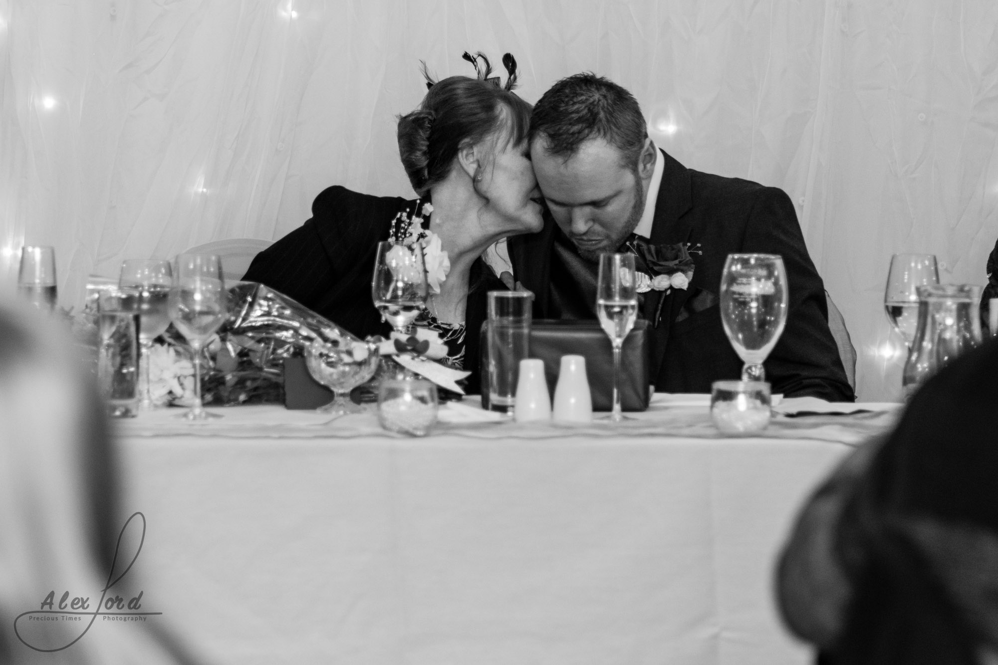 members of the brides family sit on the top table and listen to the wedding speeches