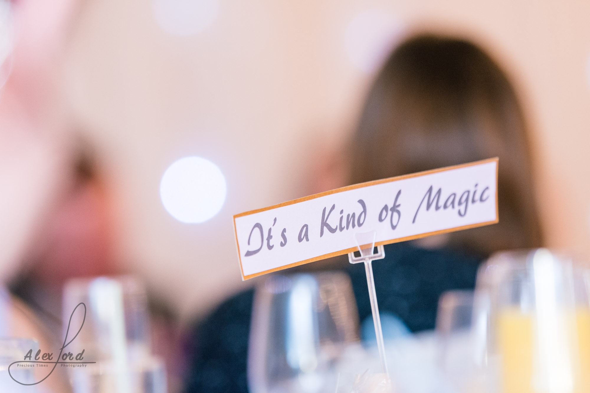 an outline of a wedding guest behind one of the wedding breakfast table names