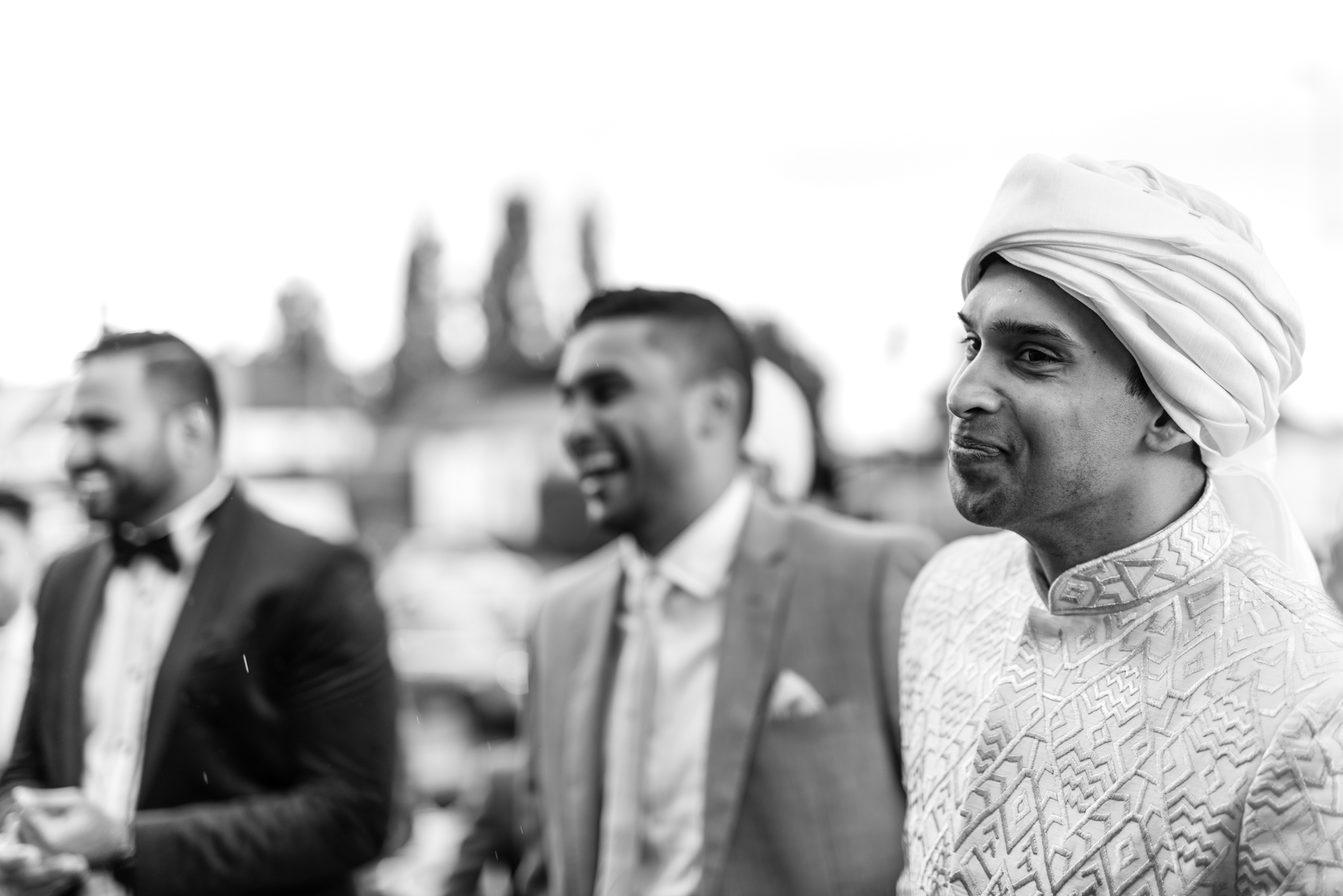 The groom arrives at the wedding venue with two of his friends