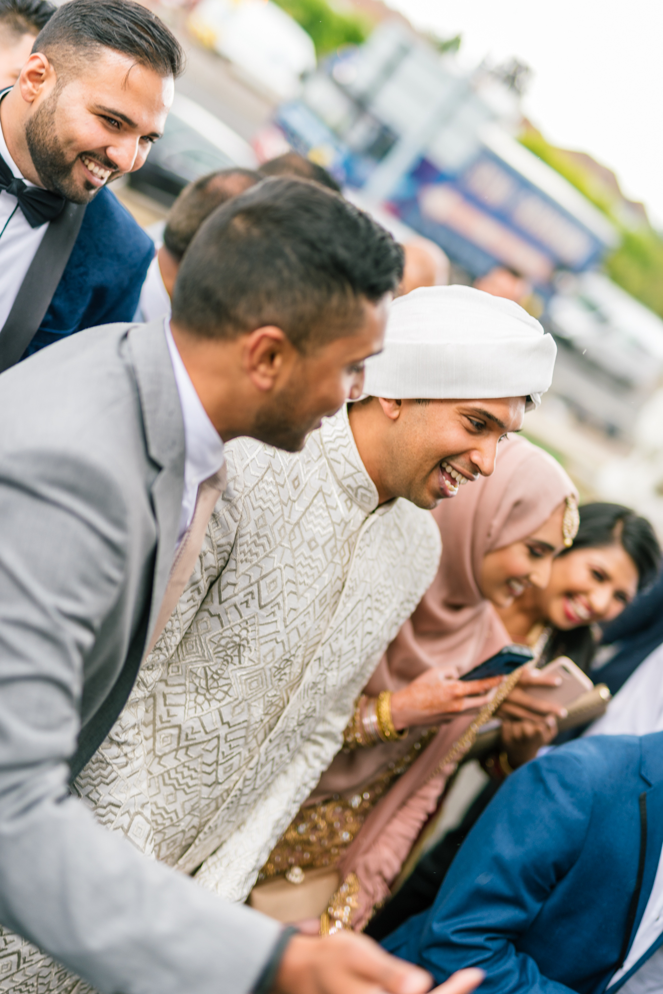 The groom in his full wedding clothes walking towards the wedding venue