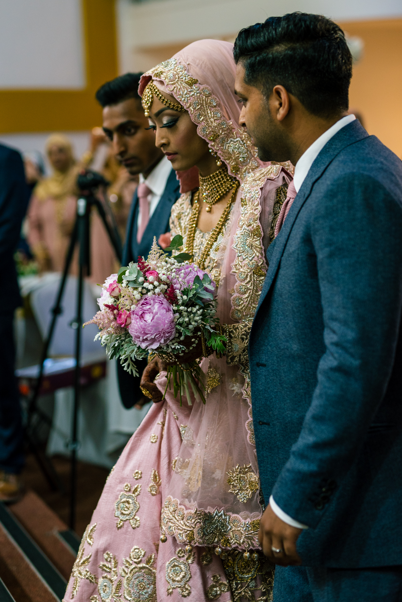The bride starts to make her entrance into the wedding venue with her dad