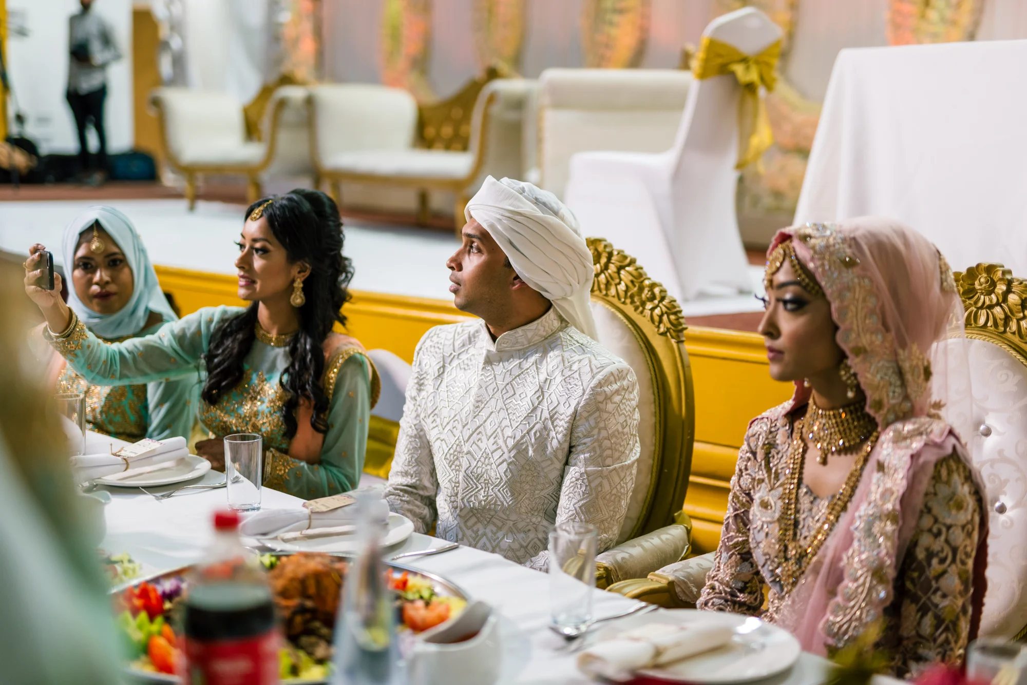 The bride and groom share their first meal together after the wedding