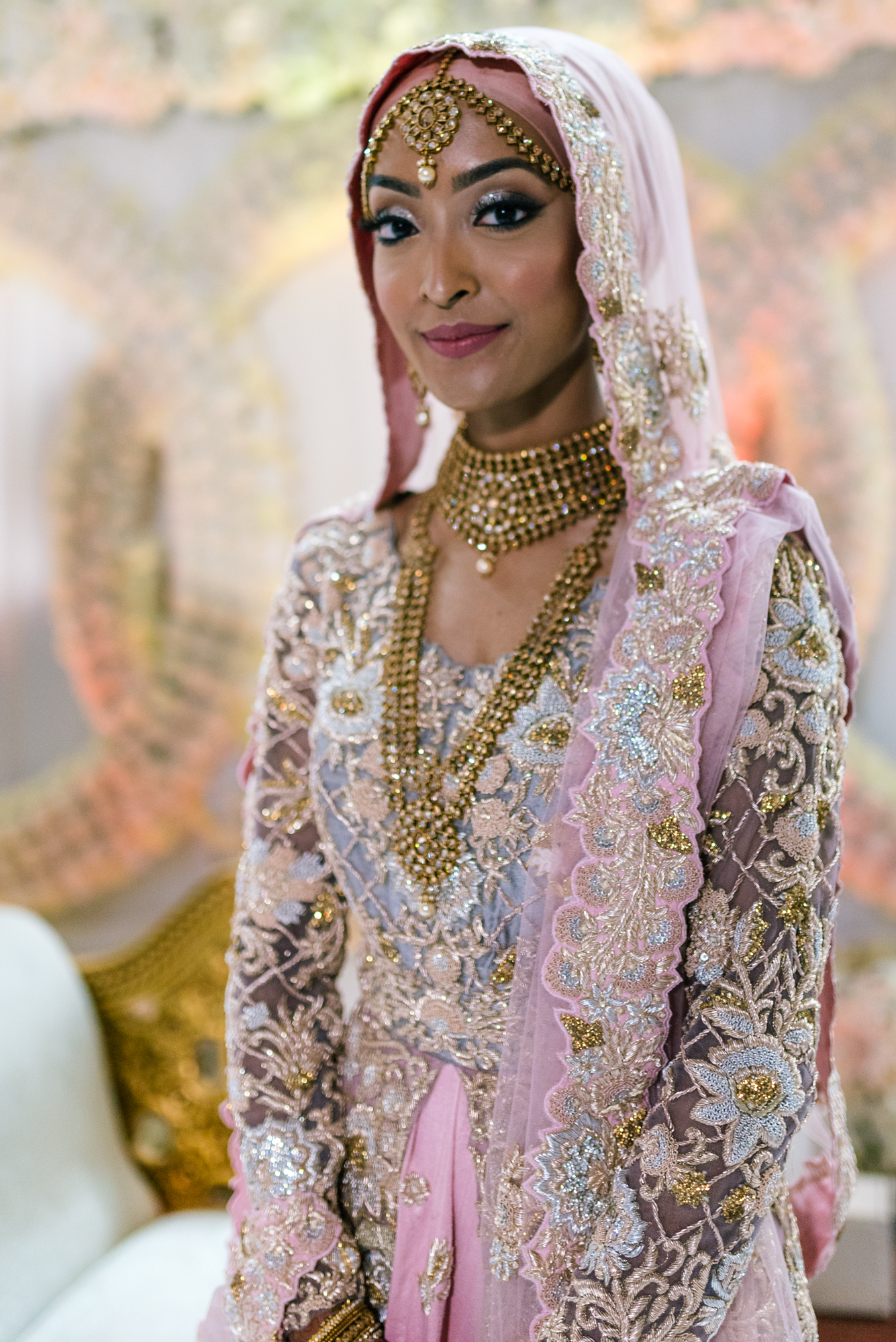 the beautiful indian bride in a spectacular pink and gold indian dress