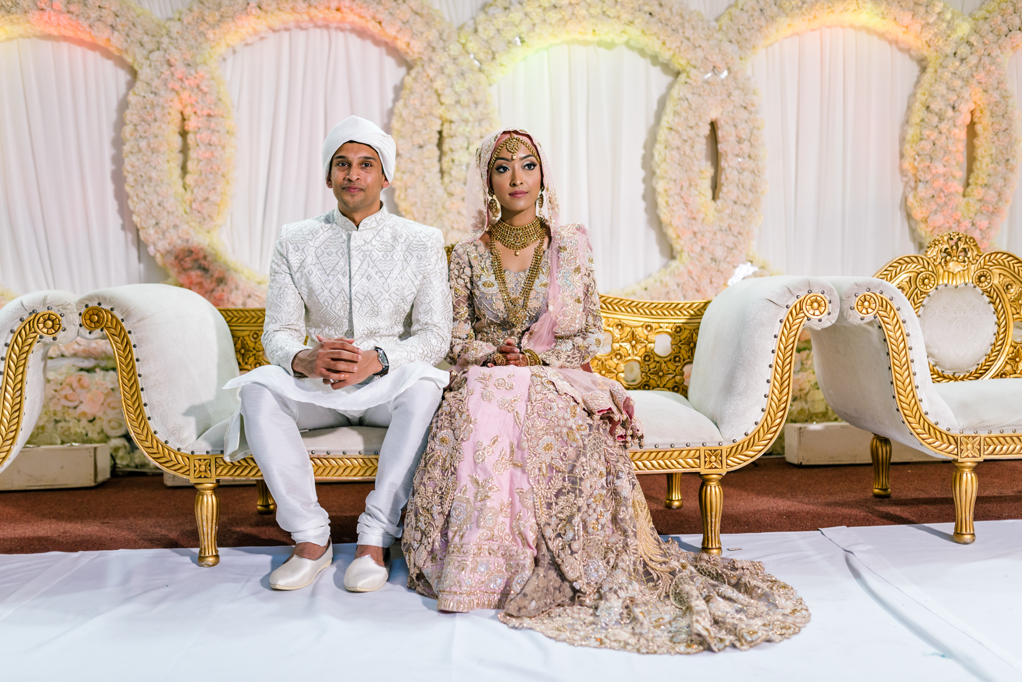 the bride and groom pose for some photos on the stage in front of all their friends and family