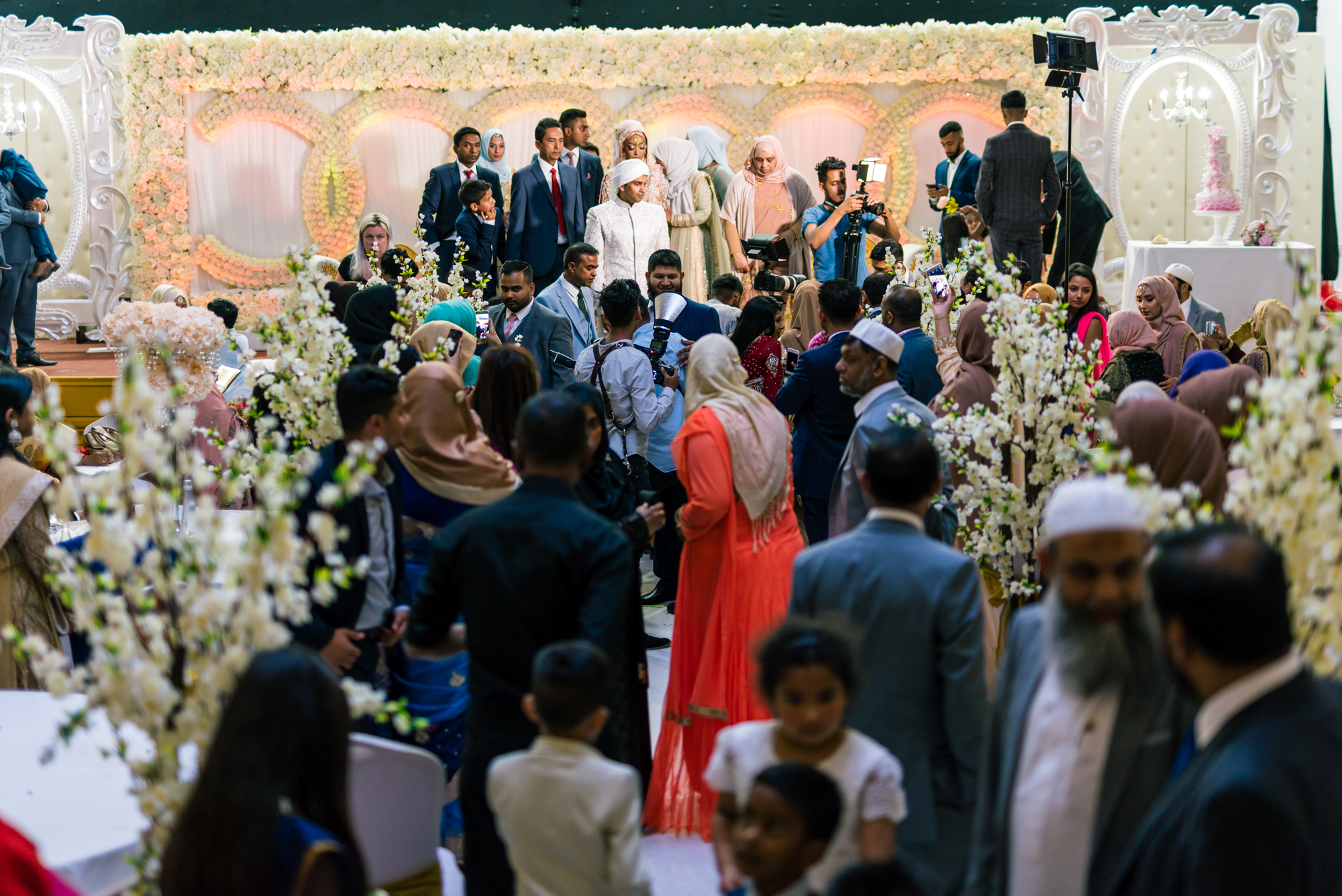 lots of wedding guests in the birmingham wedding venue standing around and chatting