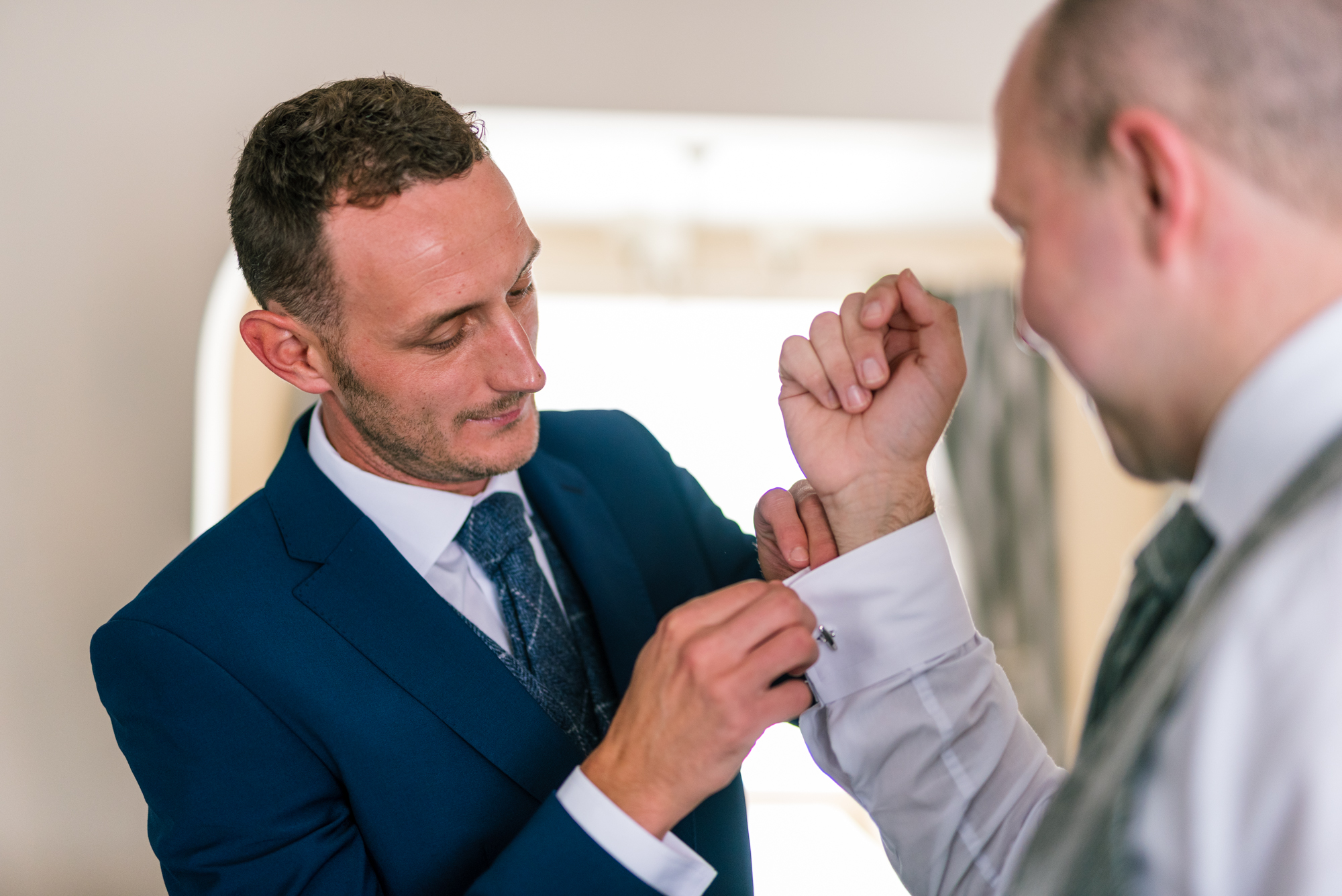 groom sorts his cufflinks