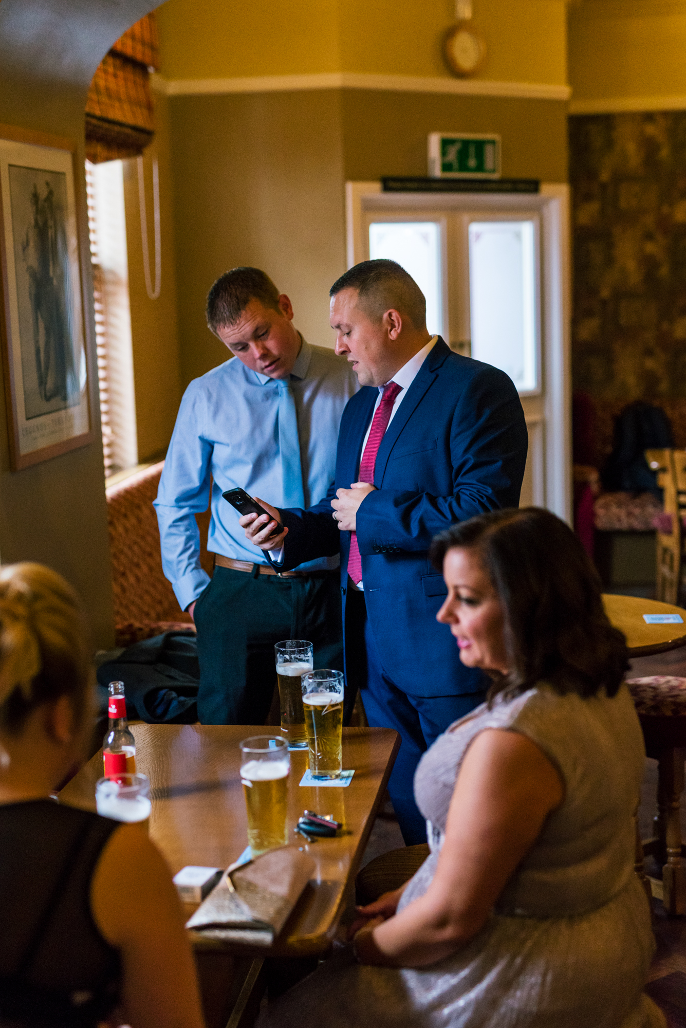 male guests enjoy a drink before the ceremony