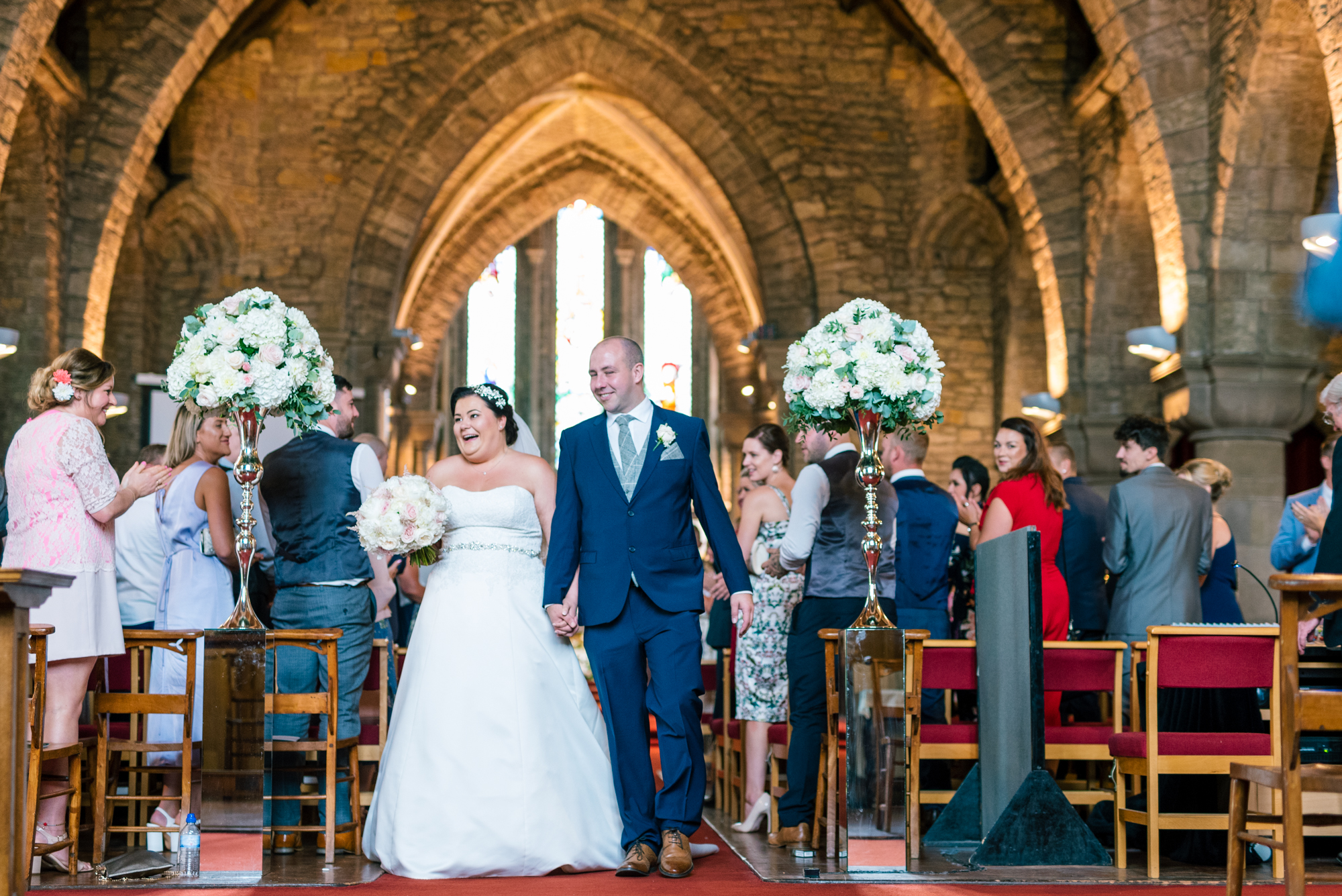 the bride and groom walk back up the aisle