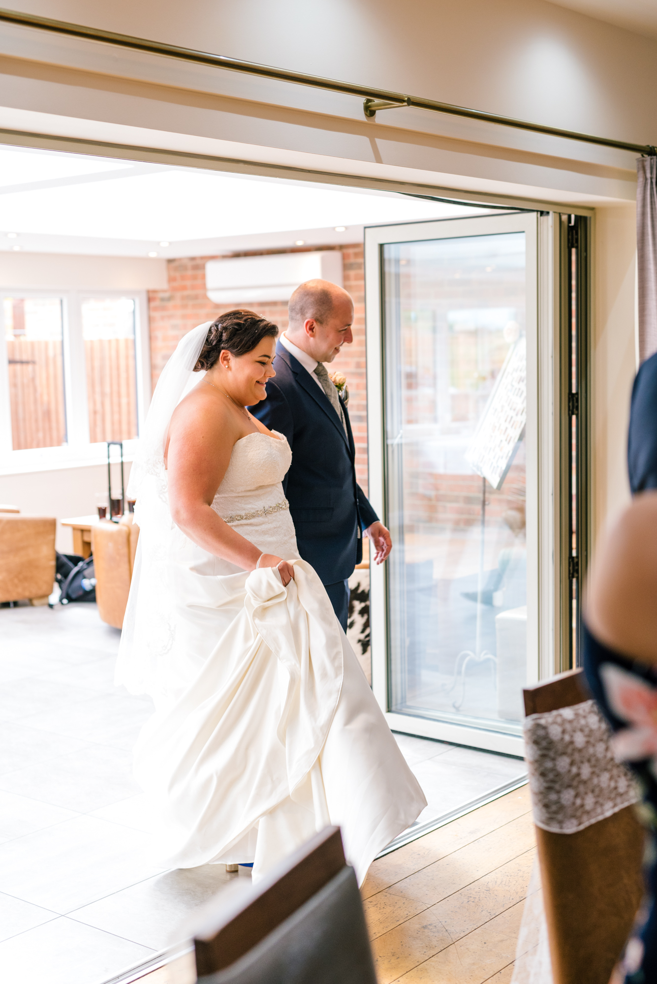 bride and groom enter the room for the wedding breakfast