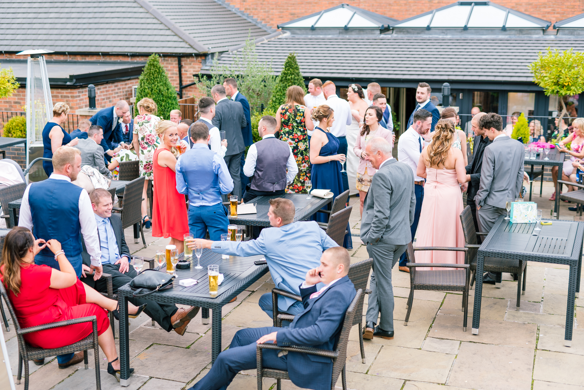 wedding guests outside enjoying a summer evening