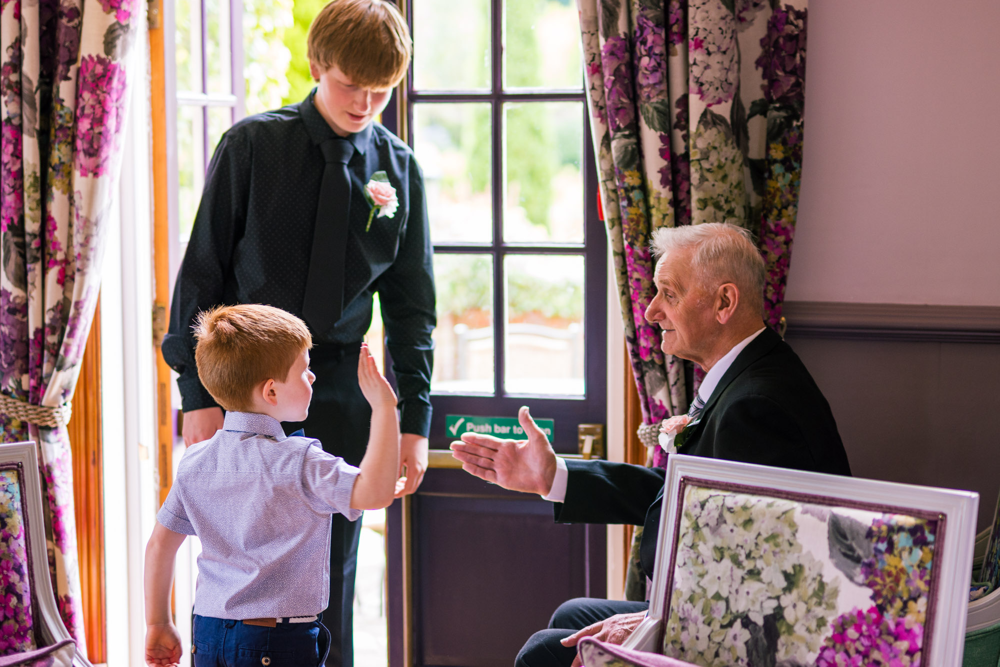 boy and his grandpa doing a high five