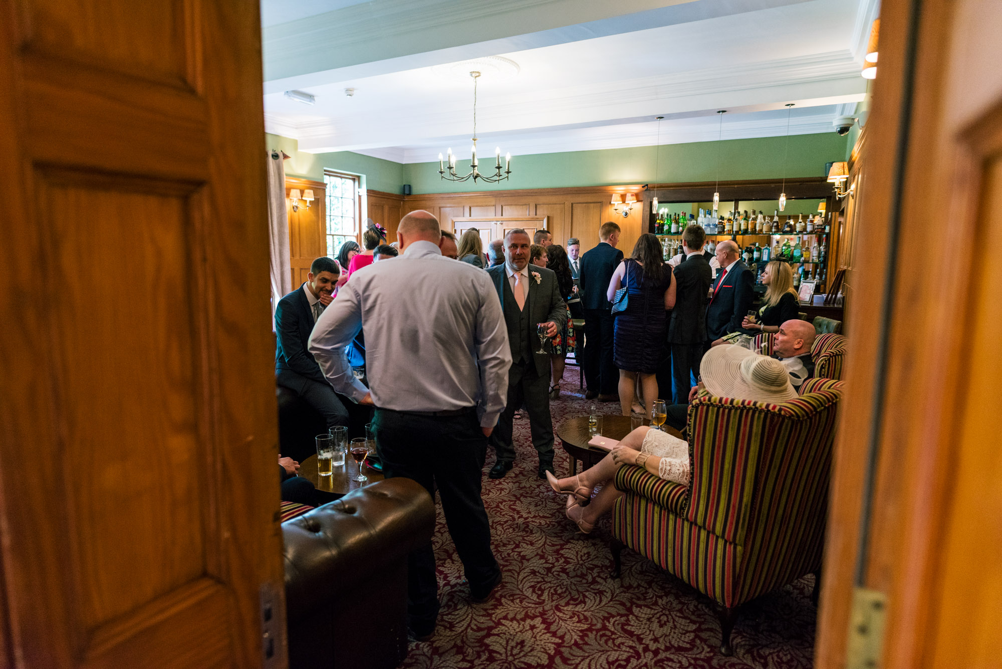 Wedding guests at the bar at Nunsmere Hall