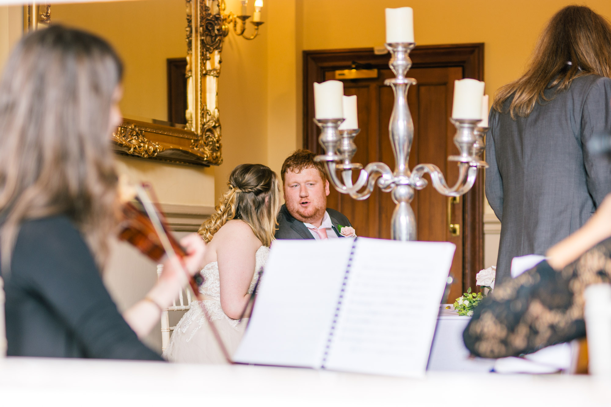 A string trio play during the signing of the register