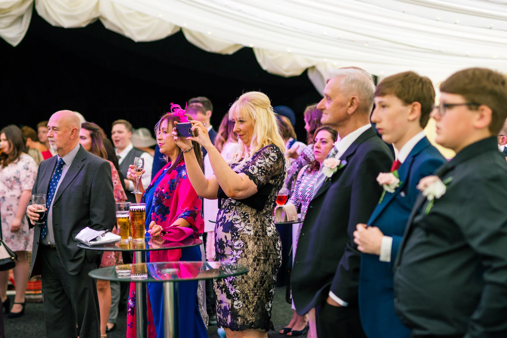 Guests taking photos of family group shots