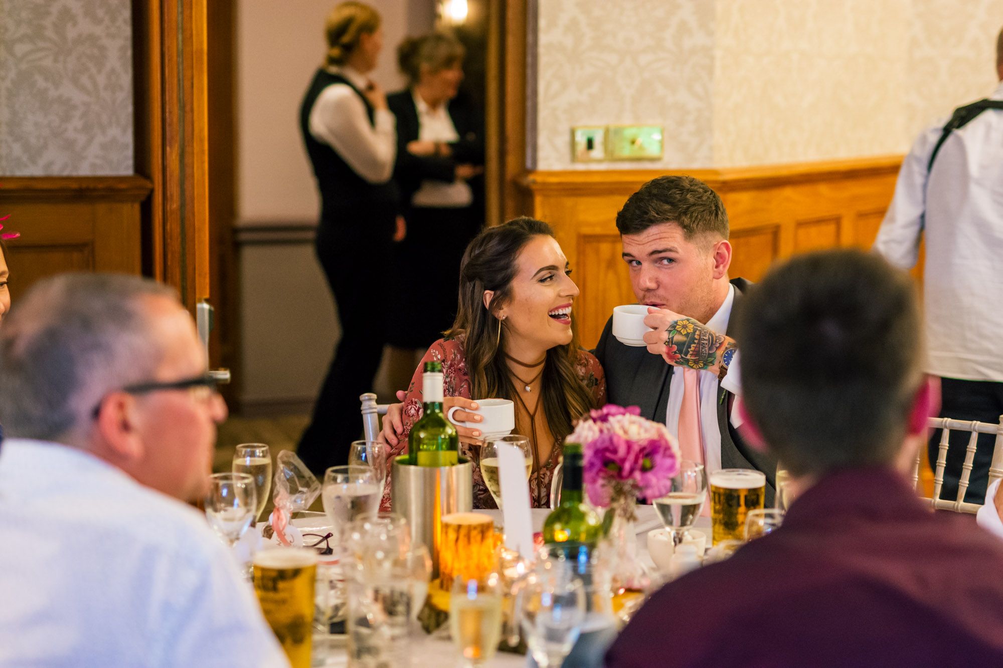 a couple have fun during the wedding breakfast