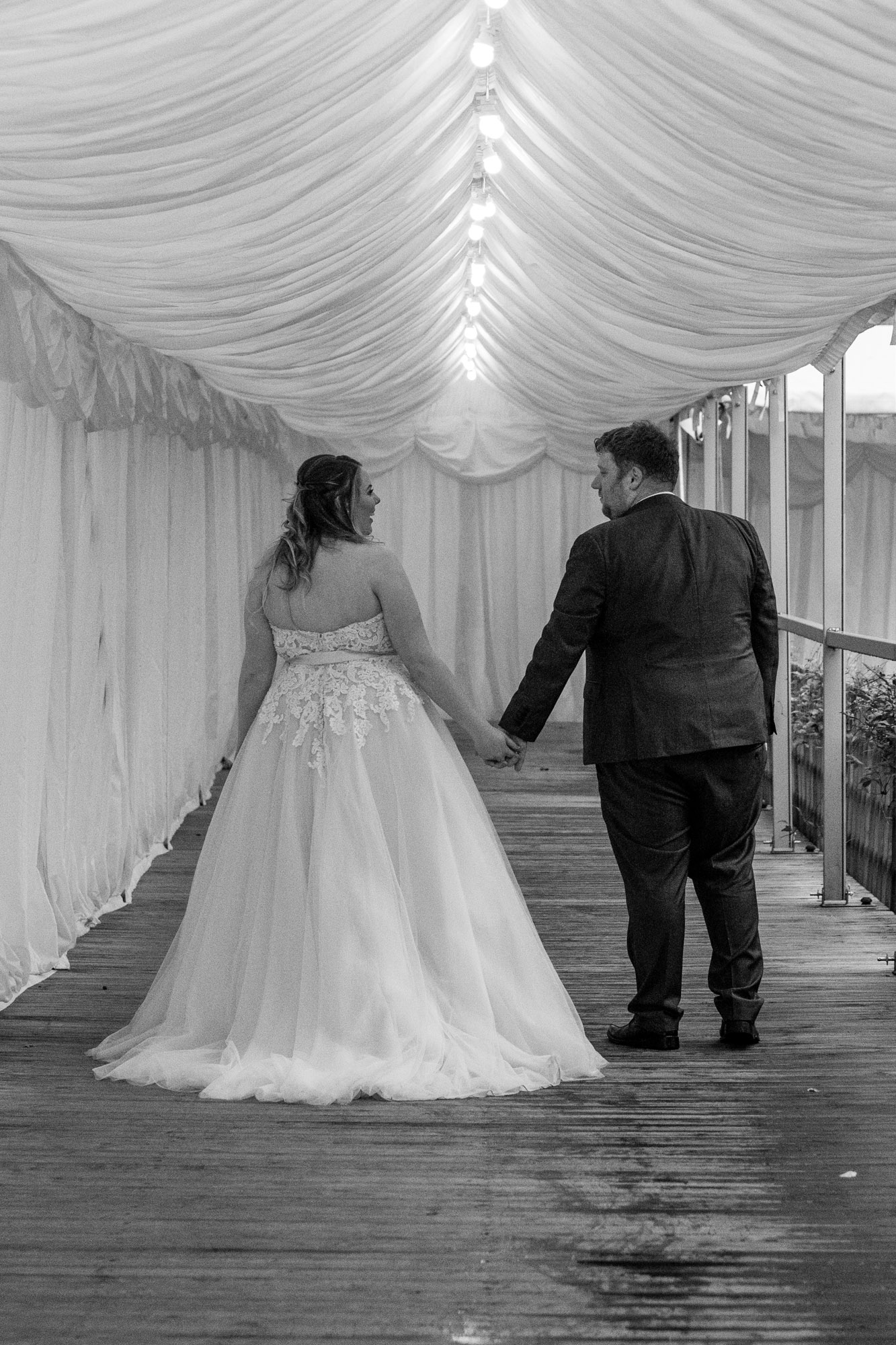 bride and groom walking away from the camera