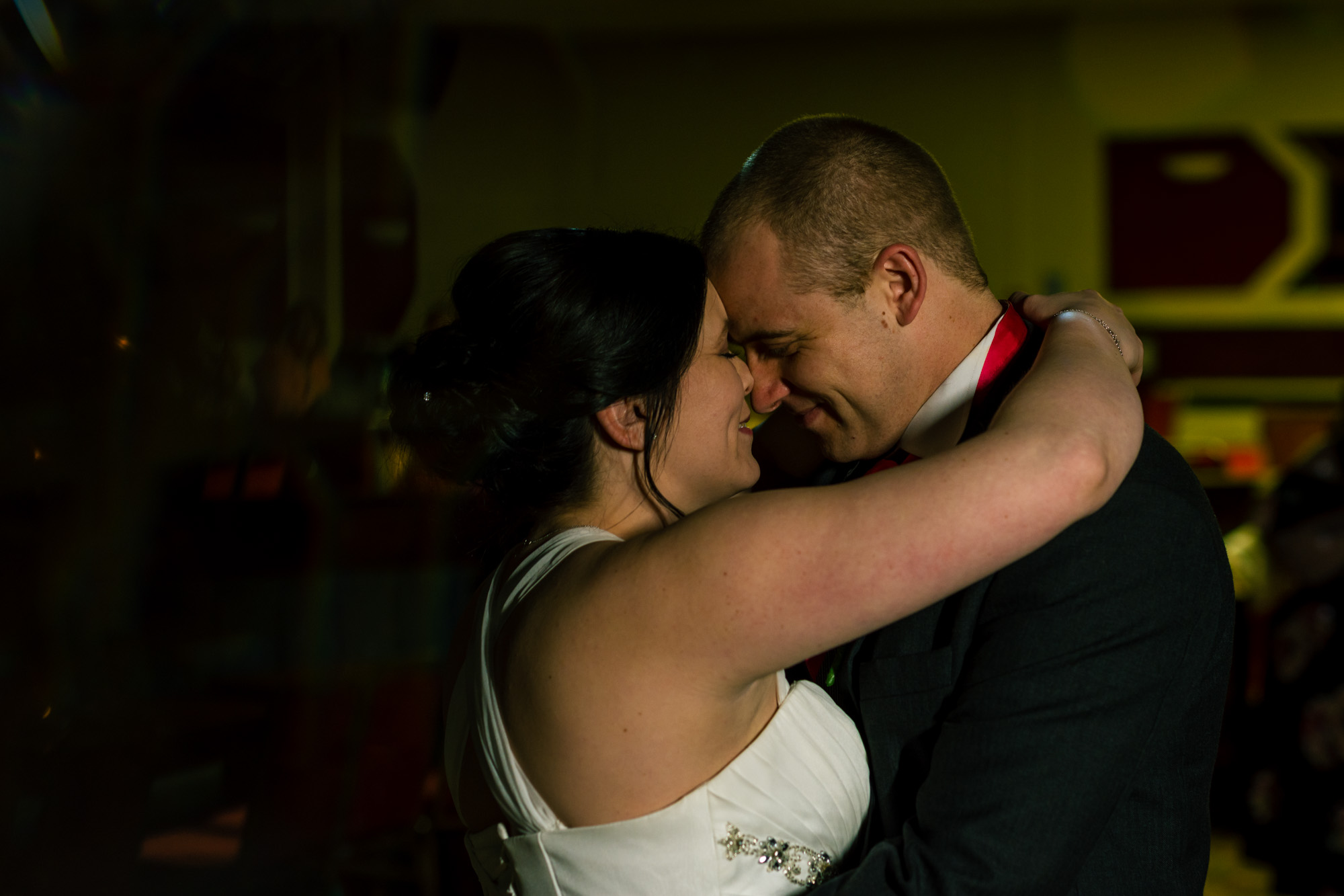 Bride and groom enjoying their first dance. Alone but with everyone around them.